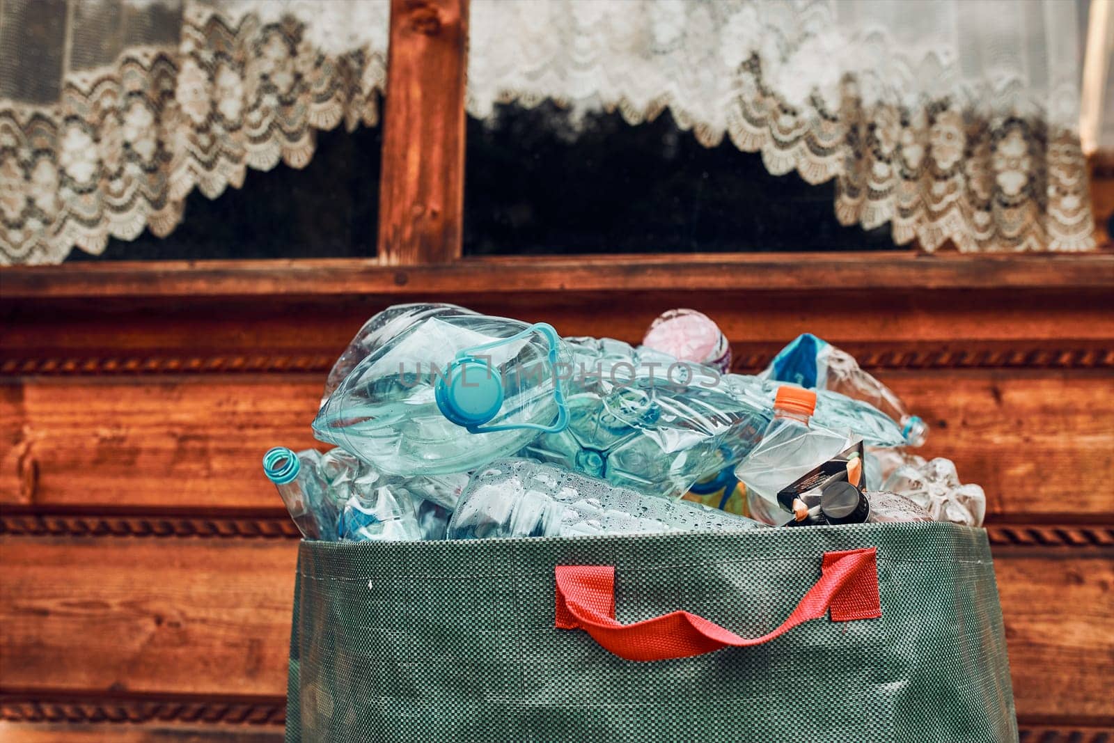 Plastic bottles collected in big container. Heap of plastic bottles, cups, bags collected to recycling. Concept of plastic pollution and too many plastic waste
