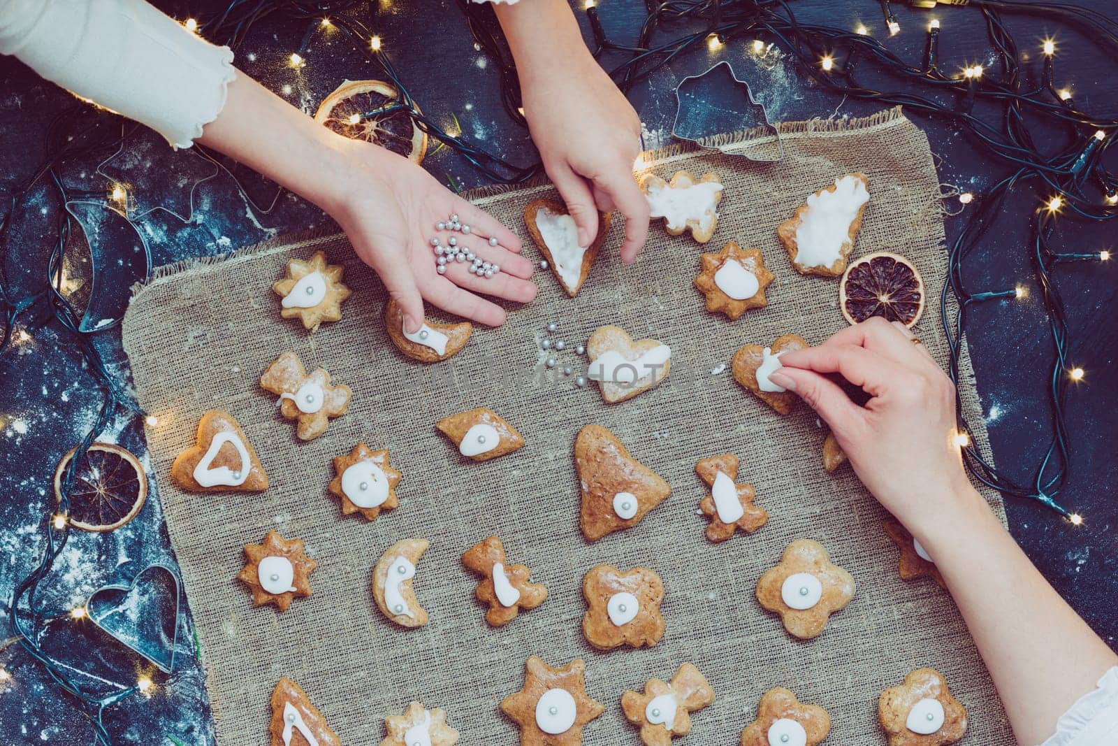 Decorating Christmas gingerbread cookies. View from above