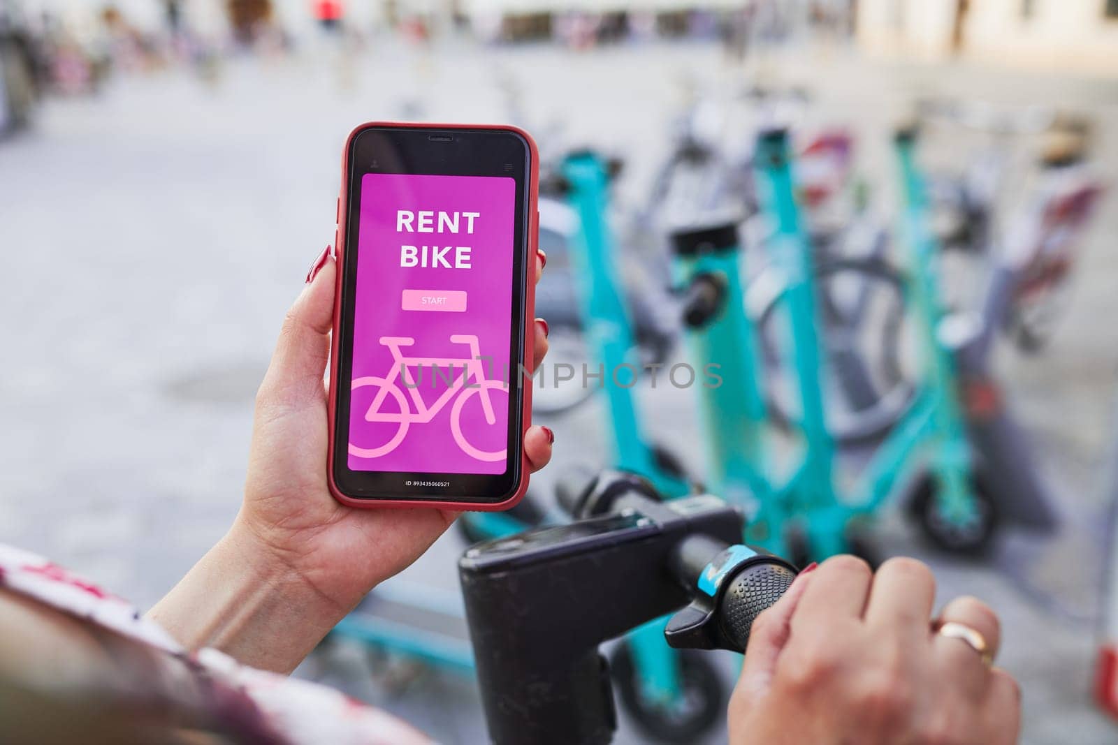Renting bike using rental app on smartphone. Using bike sharing city service. Paid rent of electric scooter. Using mobile phone to rent and pay for public eco transport. Bike sharing city station. Ecological transport alternative. 24/7 rental mobile service