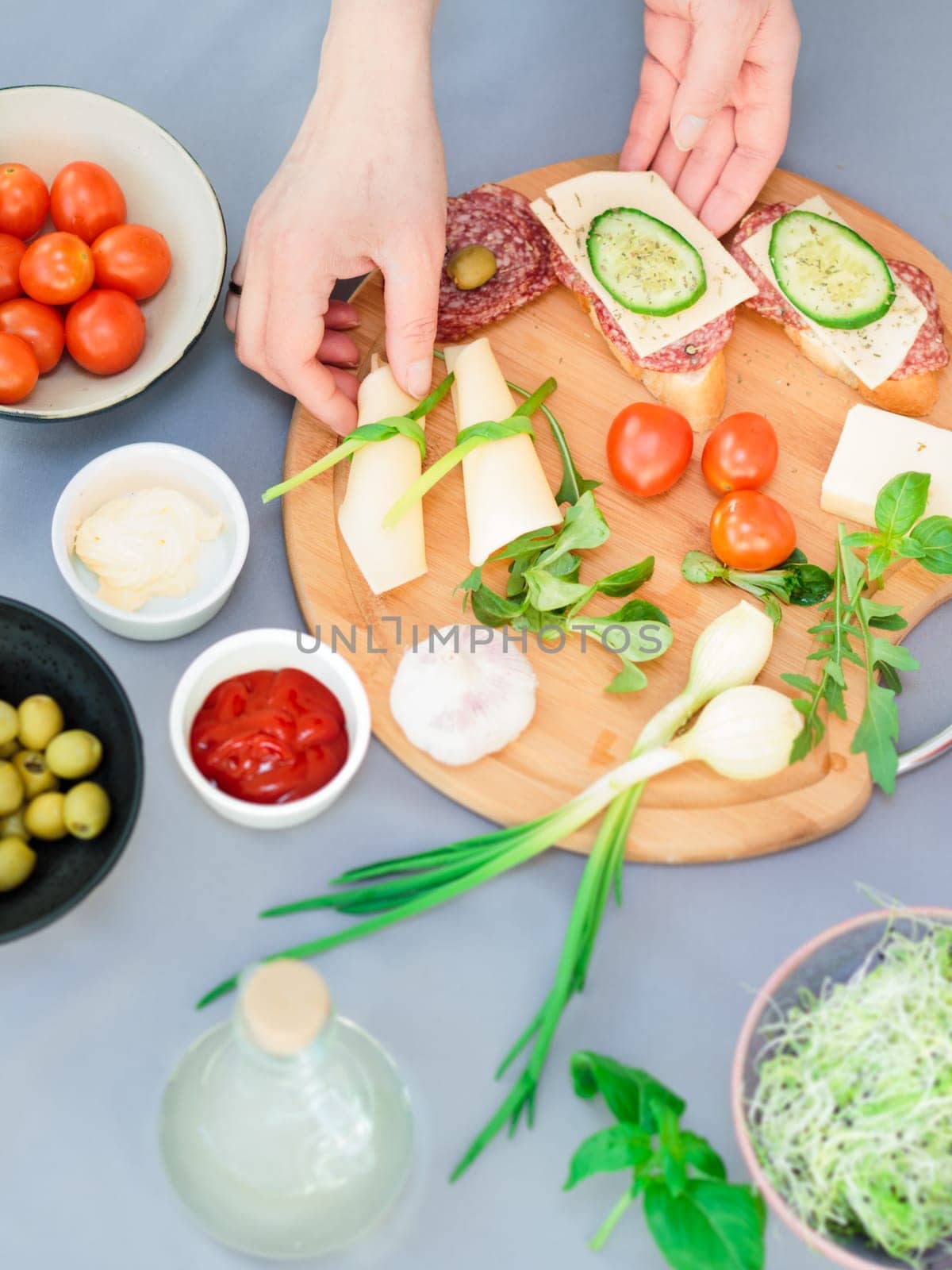 Preparing healthy snacks with fresh cheese and vegetables