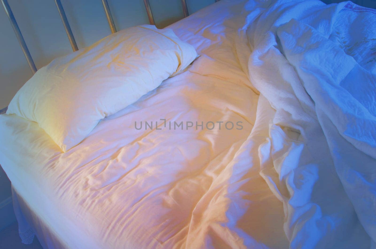 Unmade lonely bed .