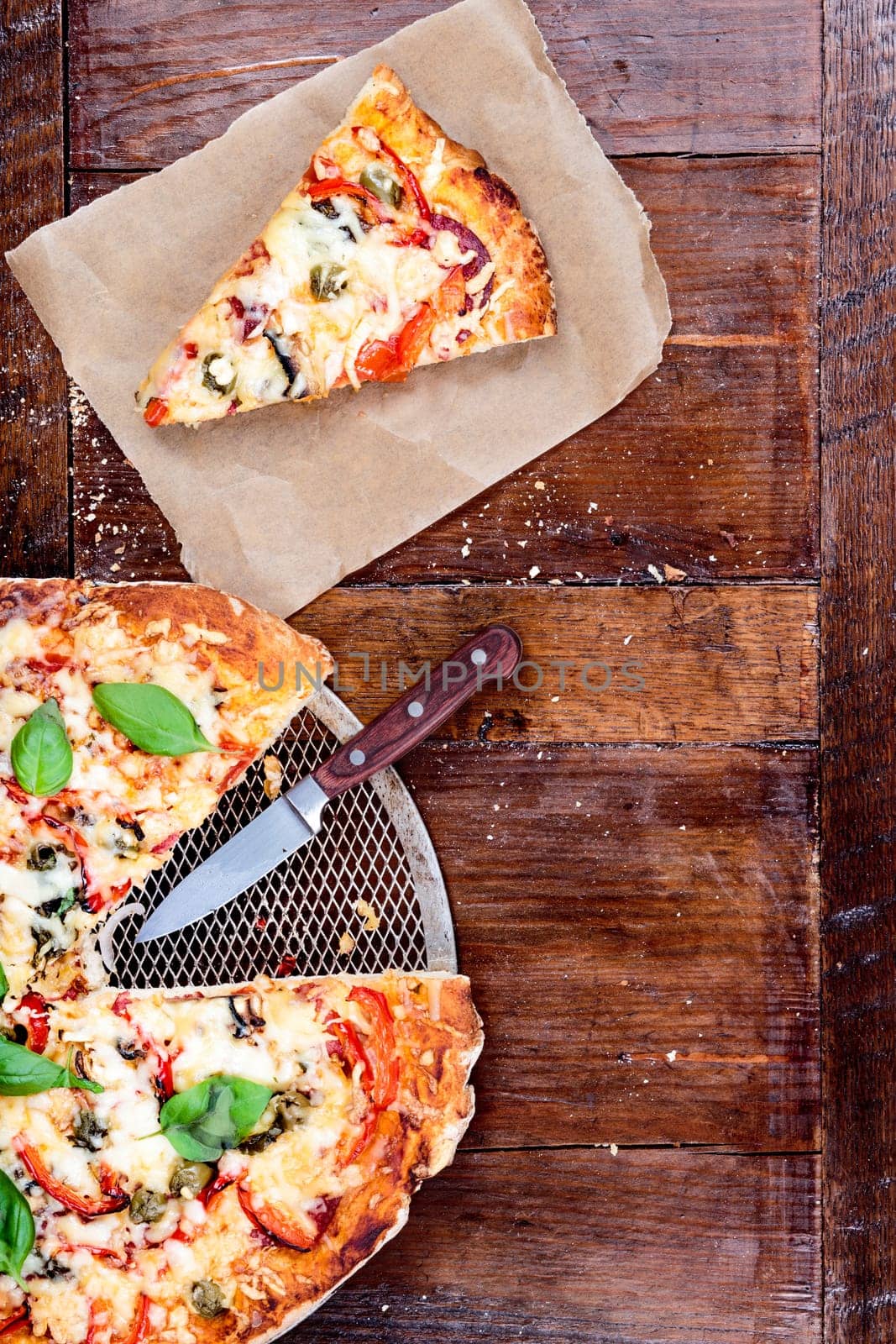 Piece of pizza on wooden table. Copy space on the right. View from above