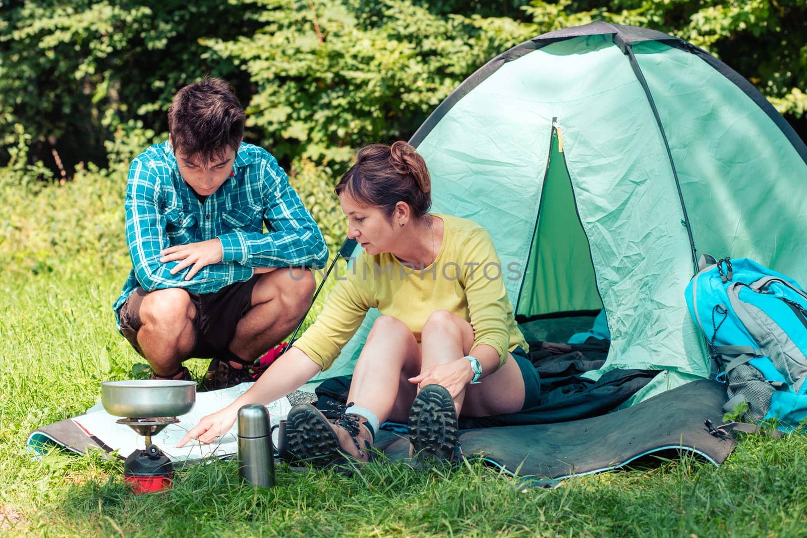 Spending a vacation on camping. Preparing a meal outdoor. Planning next trip