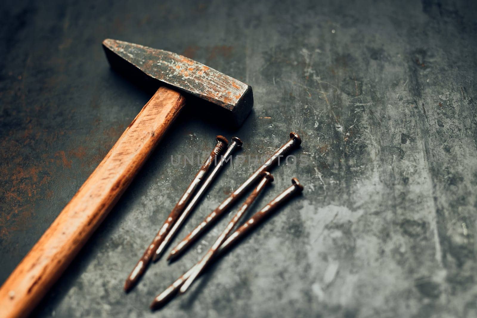 Hammer and nails on steel surface. Tools for maintenance. Hardware tools to fix. Technical background with copy space