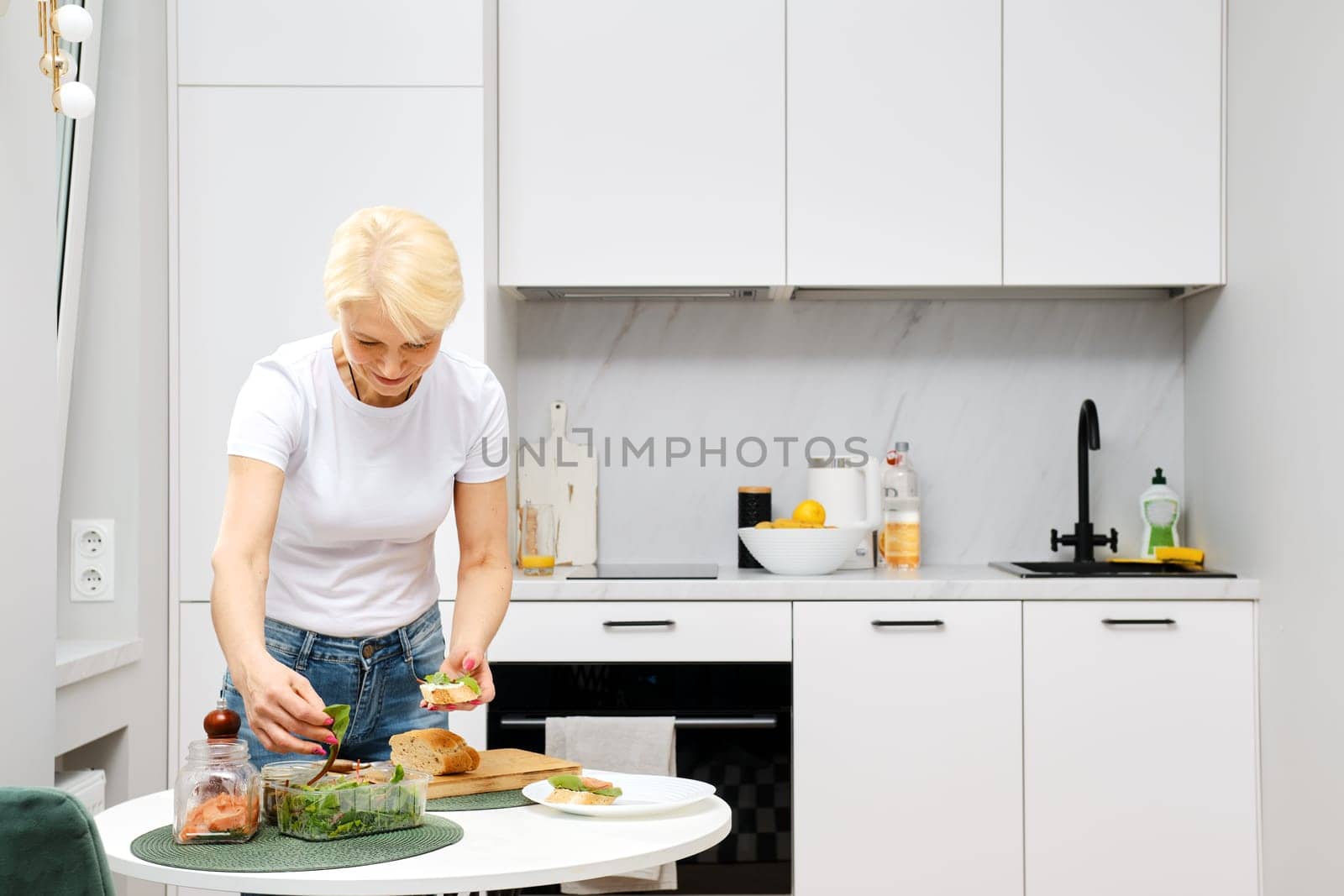 Healthy ageing concept. Adult woman makes healthy food.