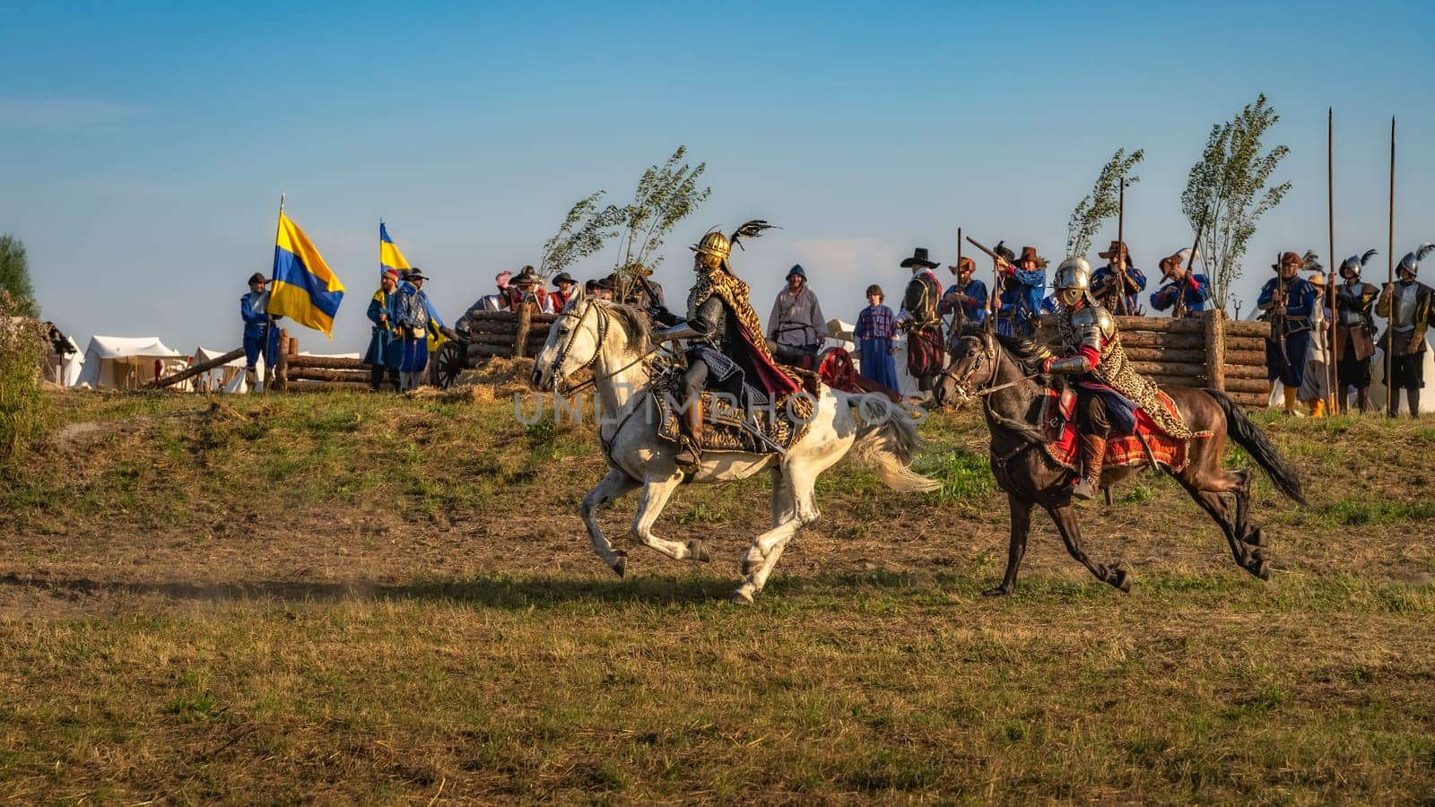 Gniew, Poland, Aug 2020 Horsman warriors, charging through a battlefield in front of fortifications, historical reenactment of Battle of Gniew
