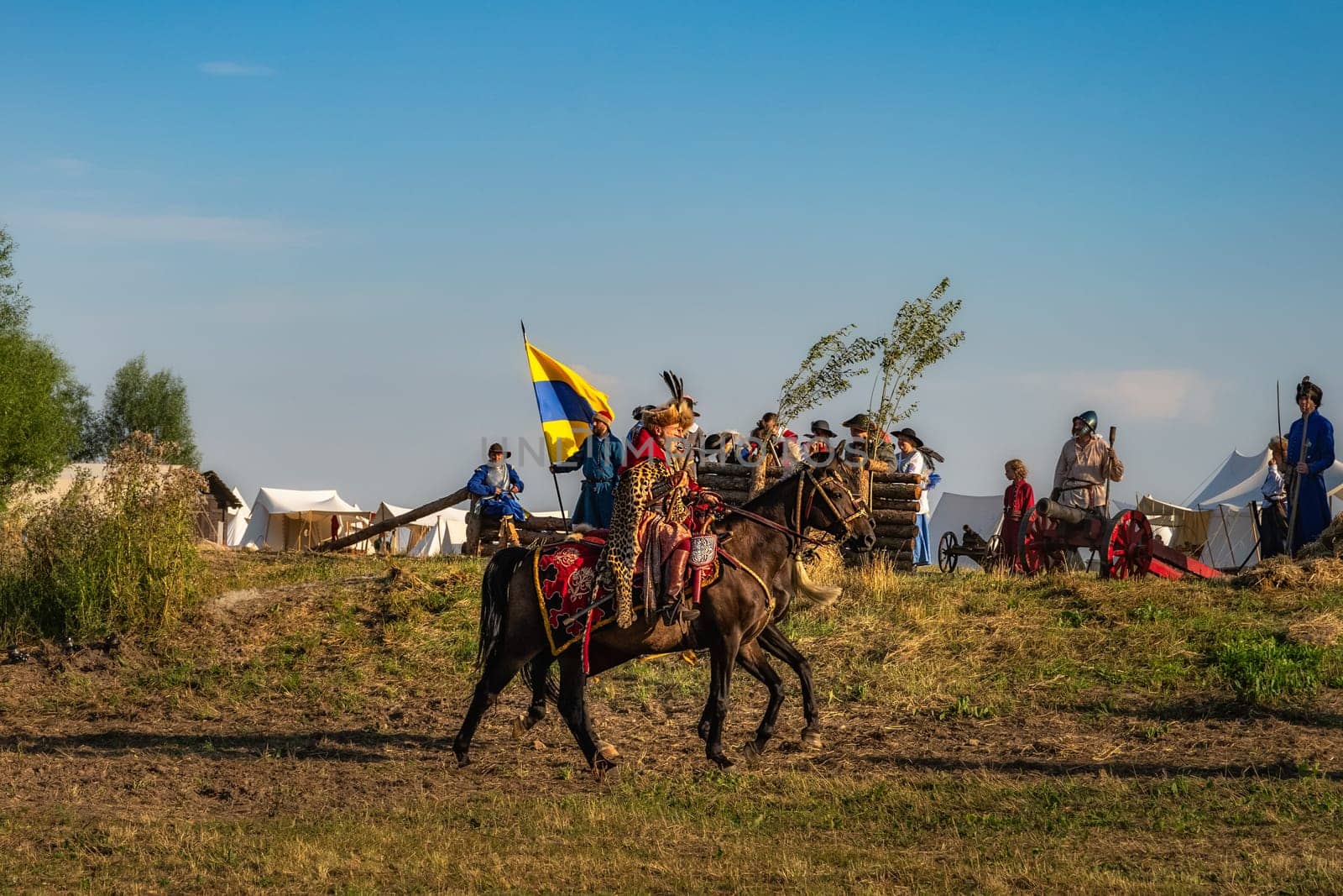Gniew, Poland, Aug 2020 Castellan, a Hussar, riding on a horse through a battlefield checking the troops, historical reenactment of Battle of Gniew