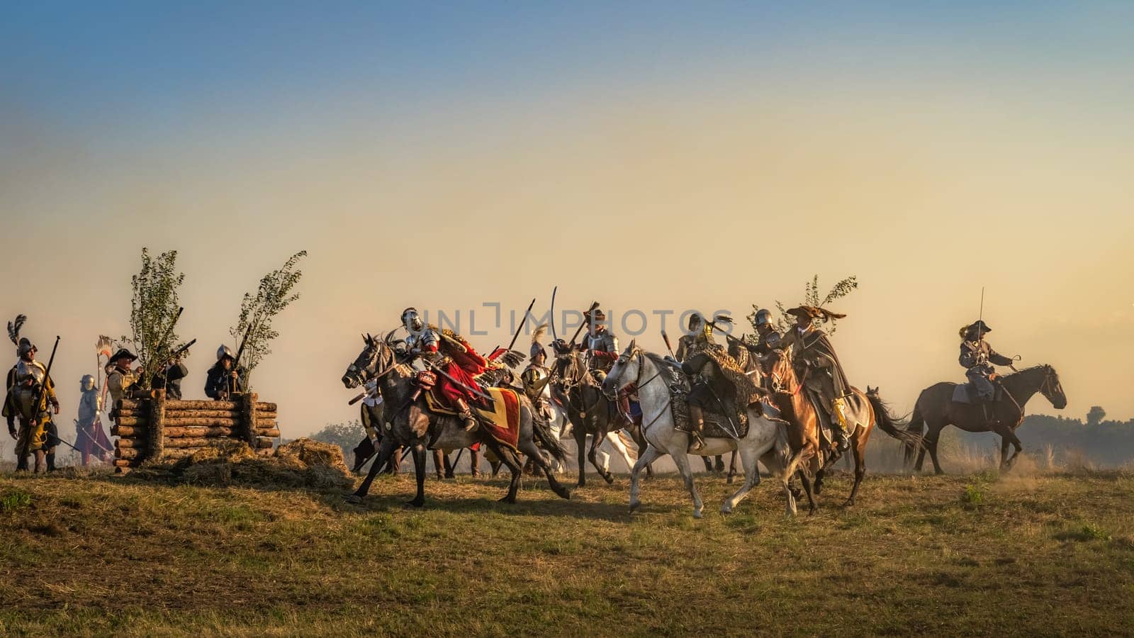Gniew, Poland, Aug 2020 Charge of the Hussars, polish heavy cavalry, at sunset, on enemy fortifications, historical reenactment of Battle of Gniew