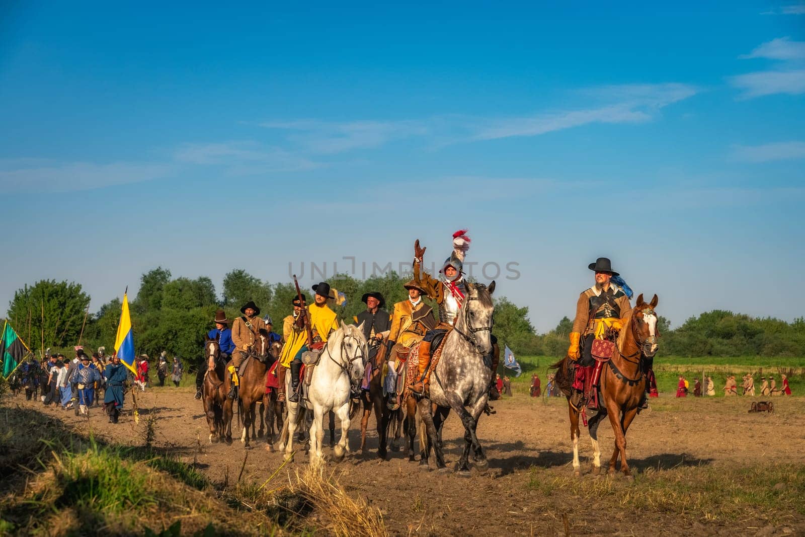 Gniew, Poland, Aug 2020 Polish hors cavalry, Hussars, riding and leading army column. Warrior waiving hand and greeting people. Historical reenactment