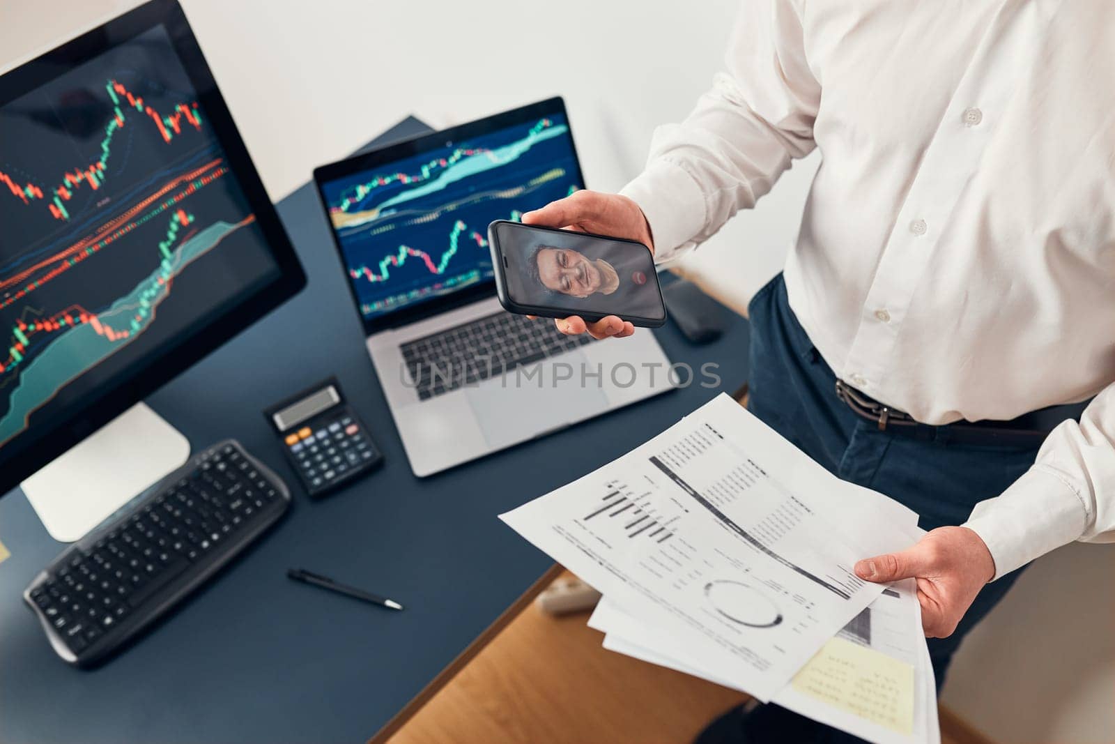 Businessman trading stocks online. Stock investor discussing numbers at graphs while video conversation with his colleague. Business team planning and analyzing stock market graphs. Man working with stock chart data. Business man investing stock using online platform. Business success concept