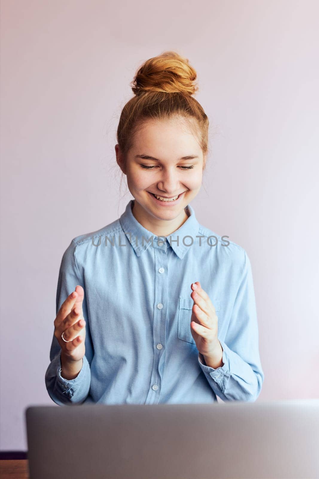 Young woman student having classes, learning online, watching lesson remotely, listening to professor, talking with classmates on video call from home during quarantine. Young girl using laptop sitting at a desk