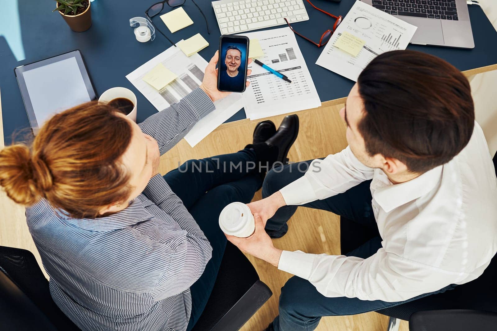 Business colleagues having video call discussing financial data working together in office. People entrepreneurs working with charts and tables on computer. Team working together. Workmates talking about project