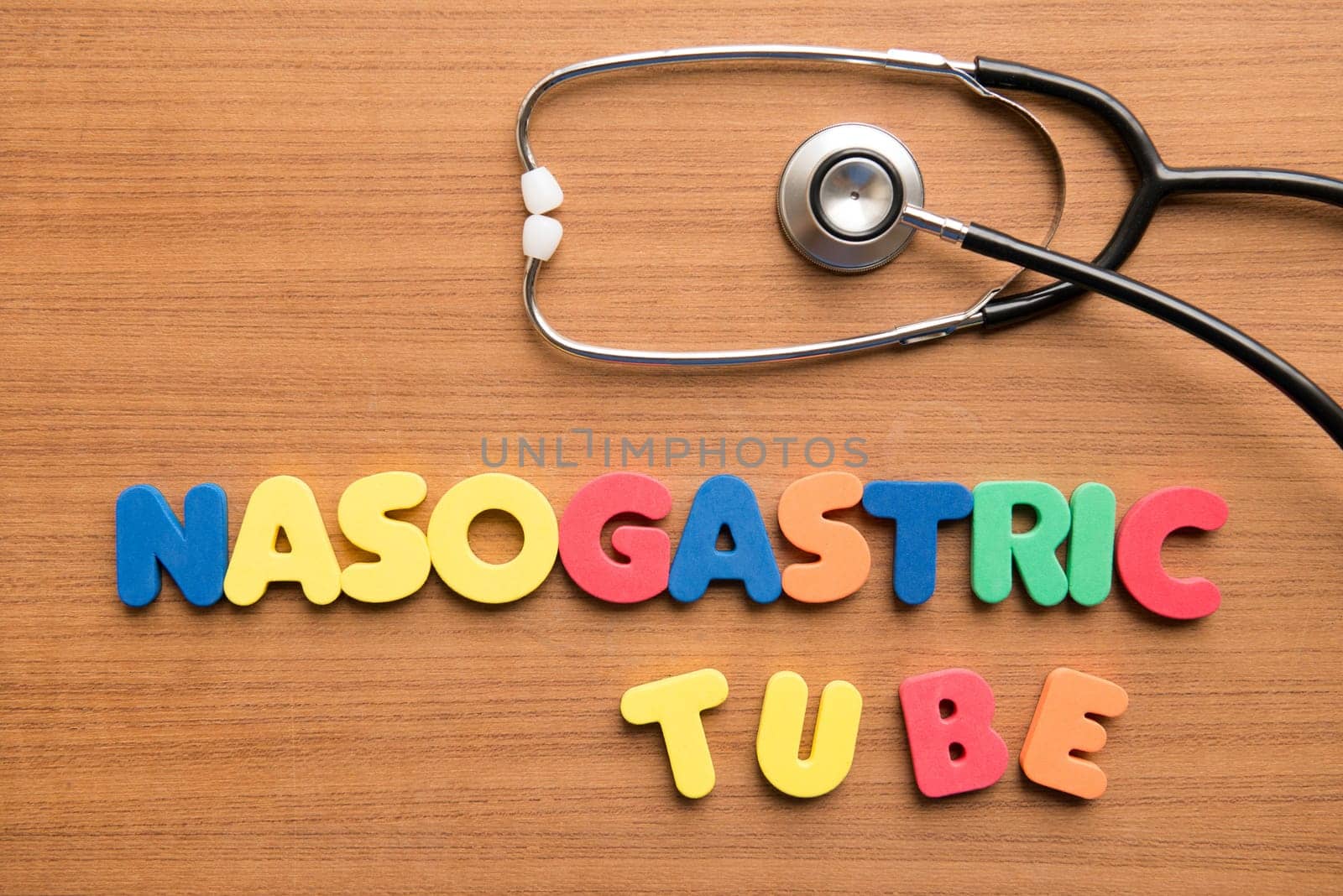 Nasogastric tube colorful word with stethoscope on the wooden background