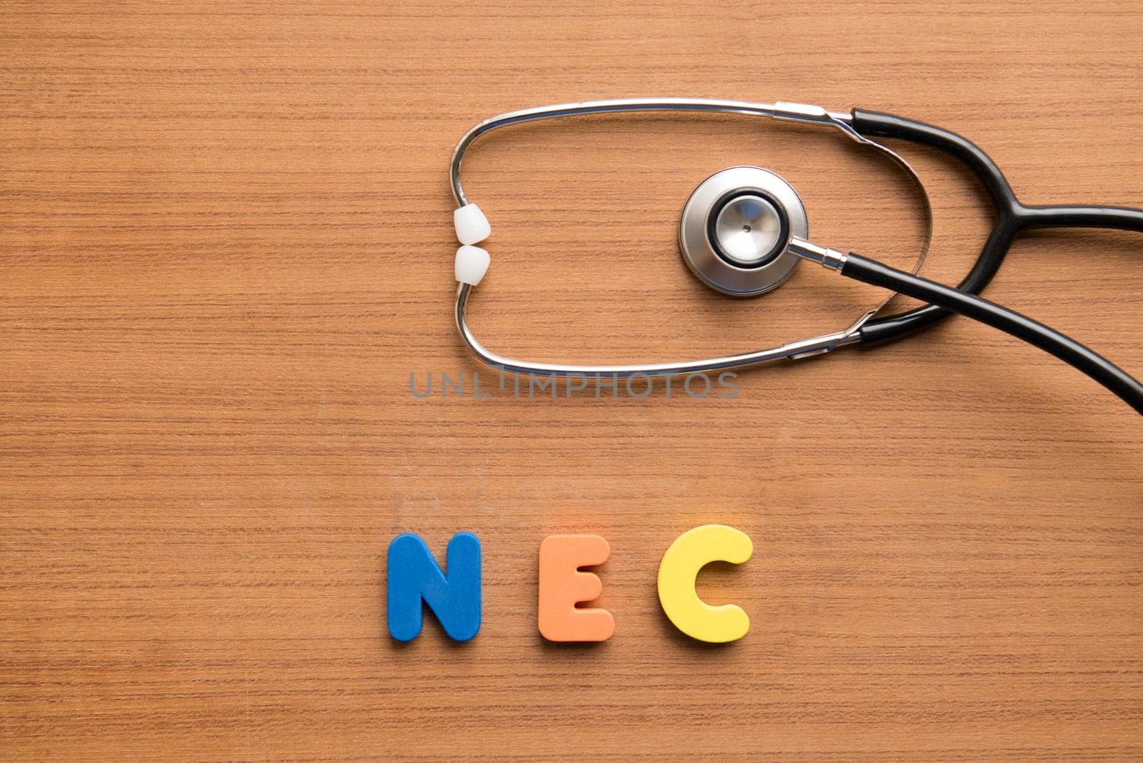 Necrotising enterocolitis (NEC) colorful word with stethoscope on the wooden background