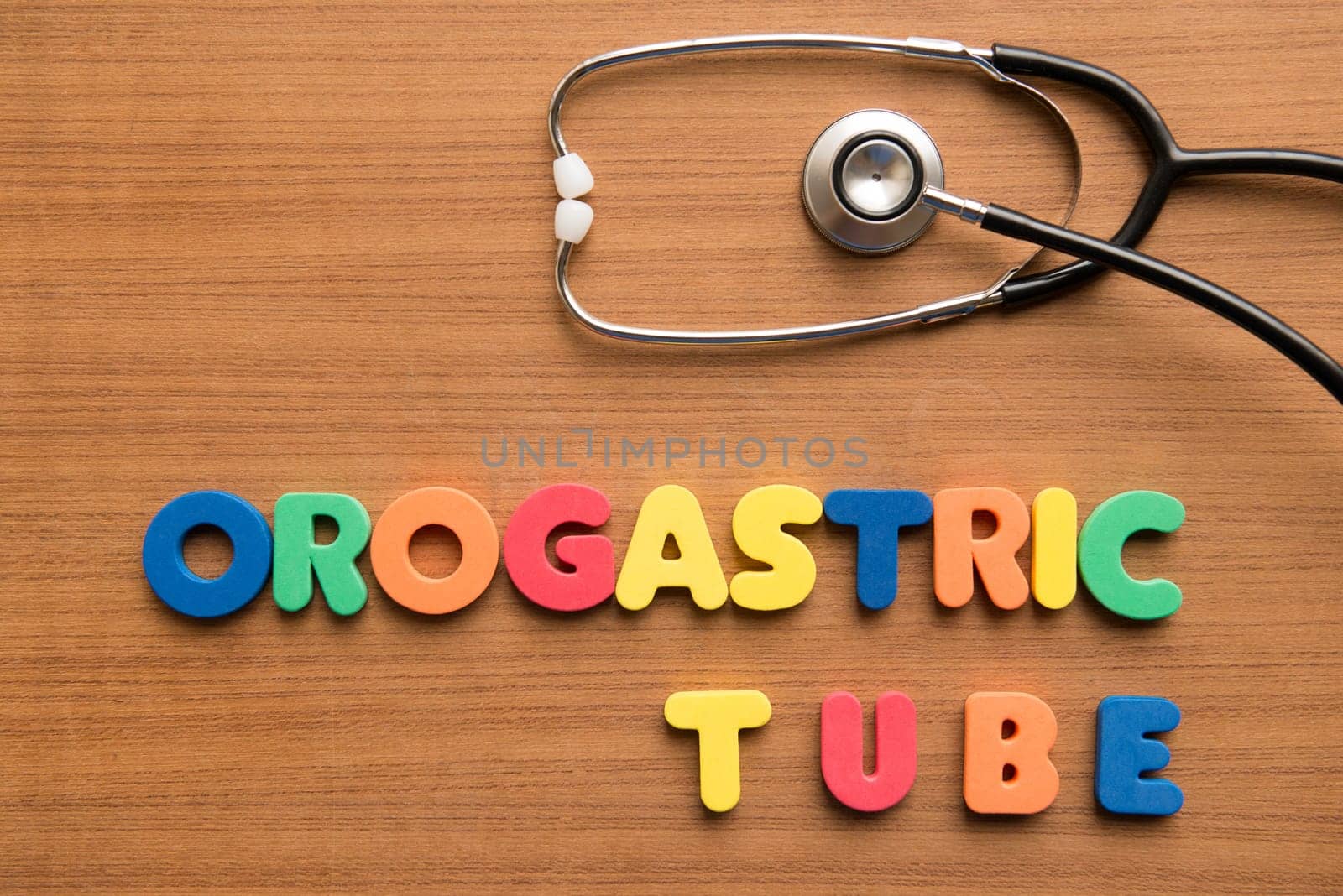 Orogastric tube colorful word with stethoscope on the wooden background