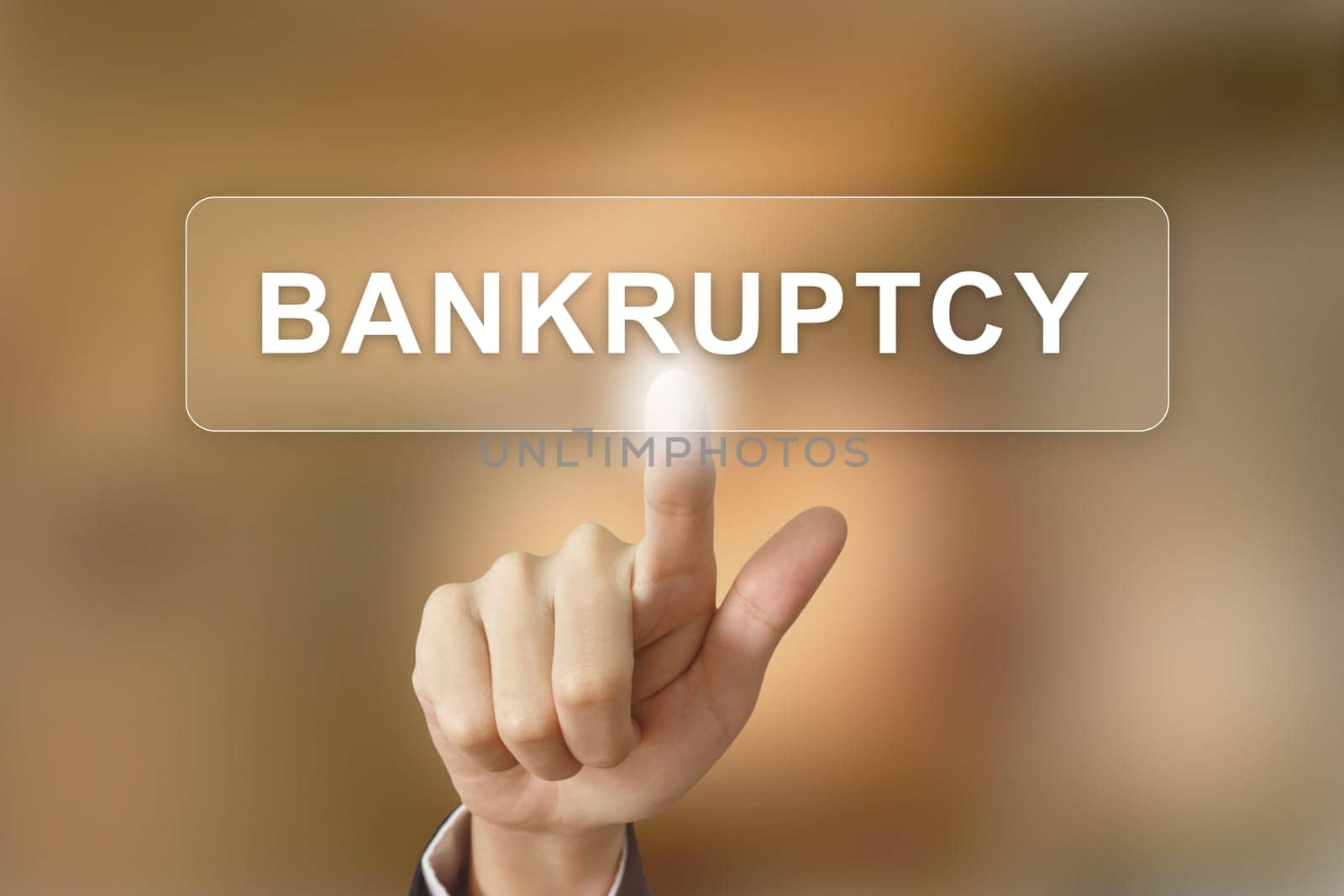 business hand pushing bankruptcy button on blurred background