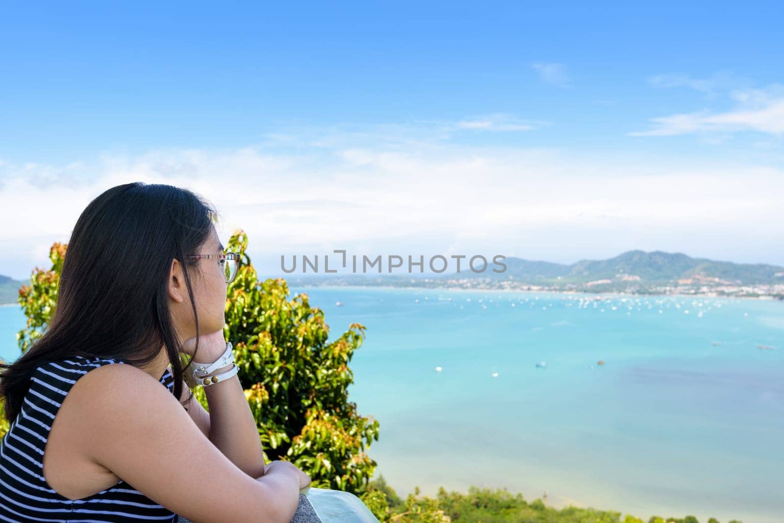 Side of the women tourist looking at beautiful nature sea and island on Khao-Khad mountain viewpoint famous attractions in Phuket Province, Thailand