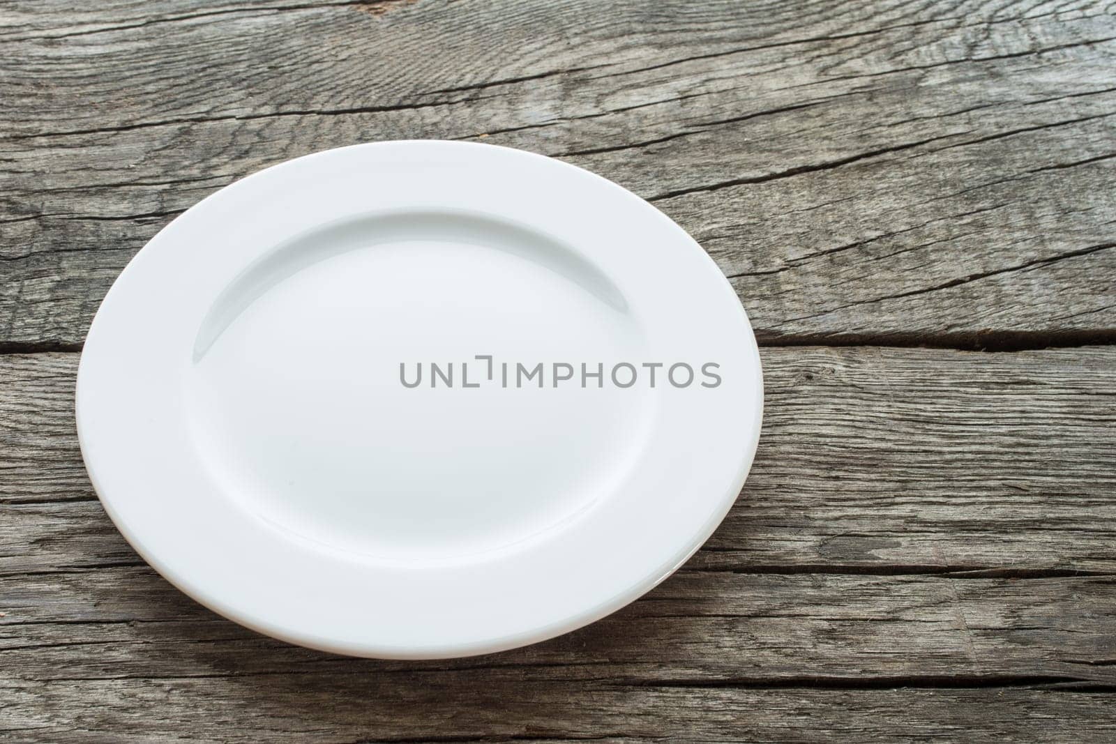 Empty plate on rustic wooden table
