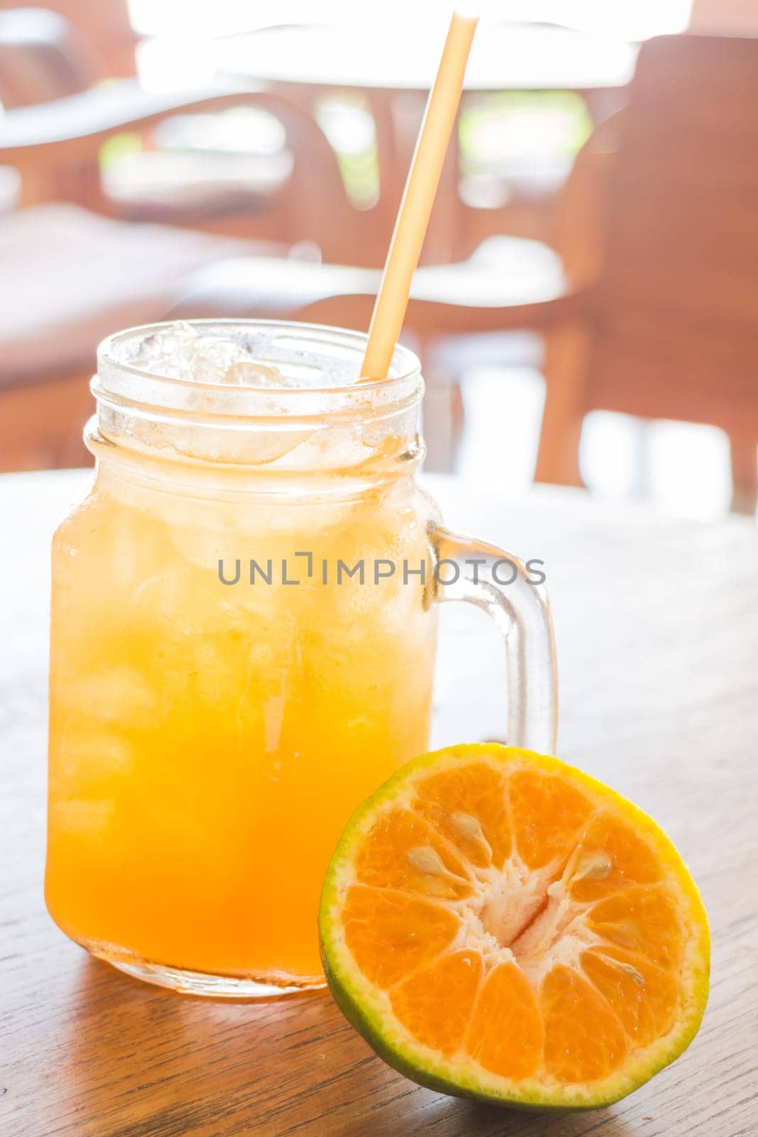 Fresh orange juice serving on wooden table, stock photo