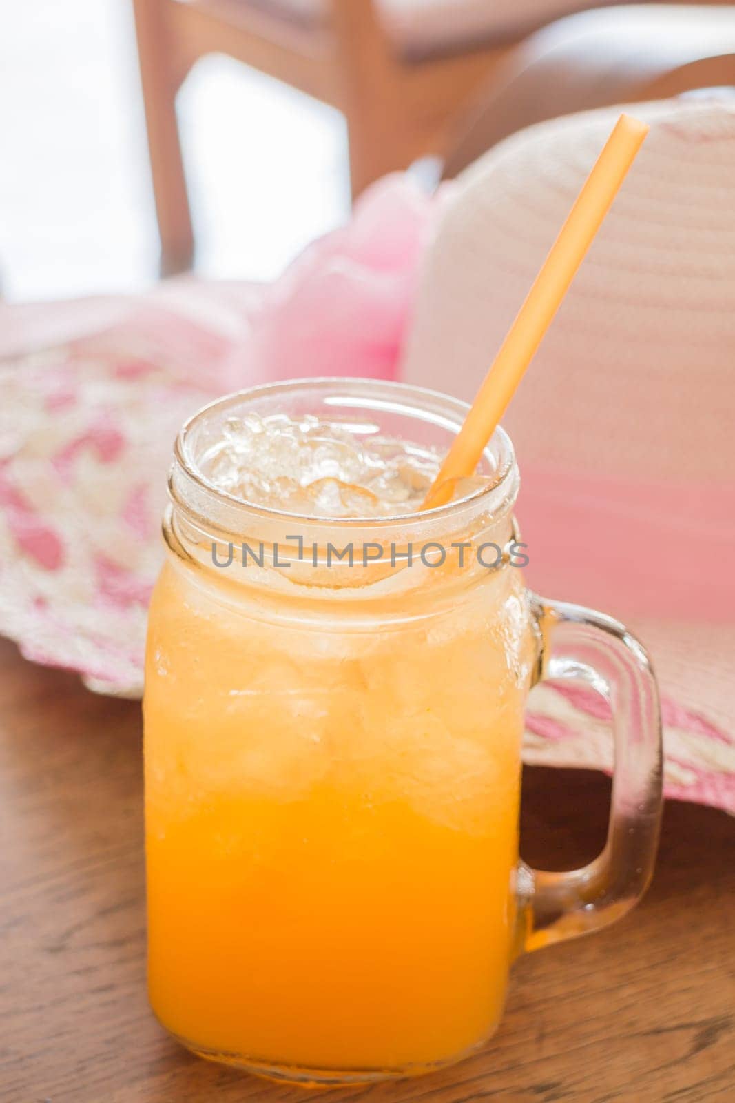 Fresh orange juice serving on wooden table, stock photo