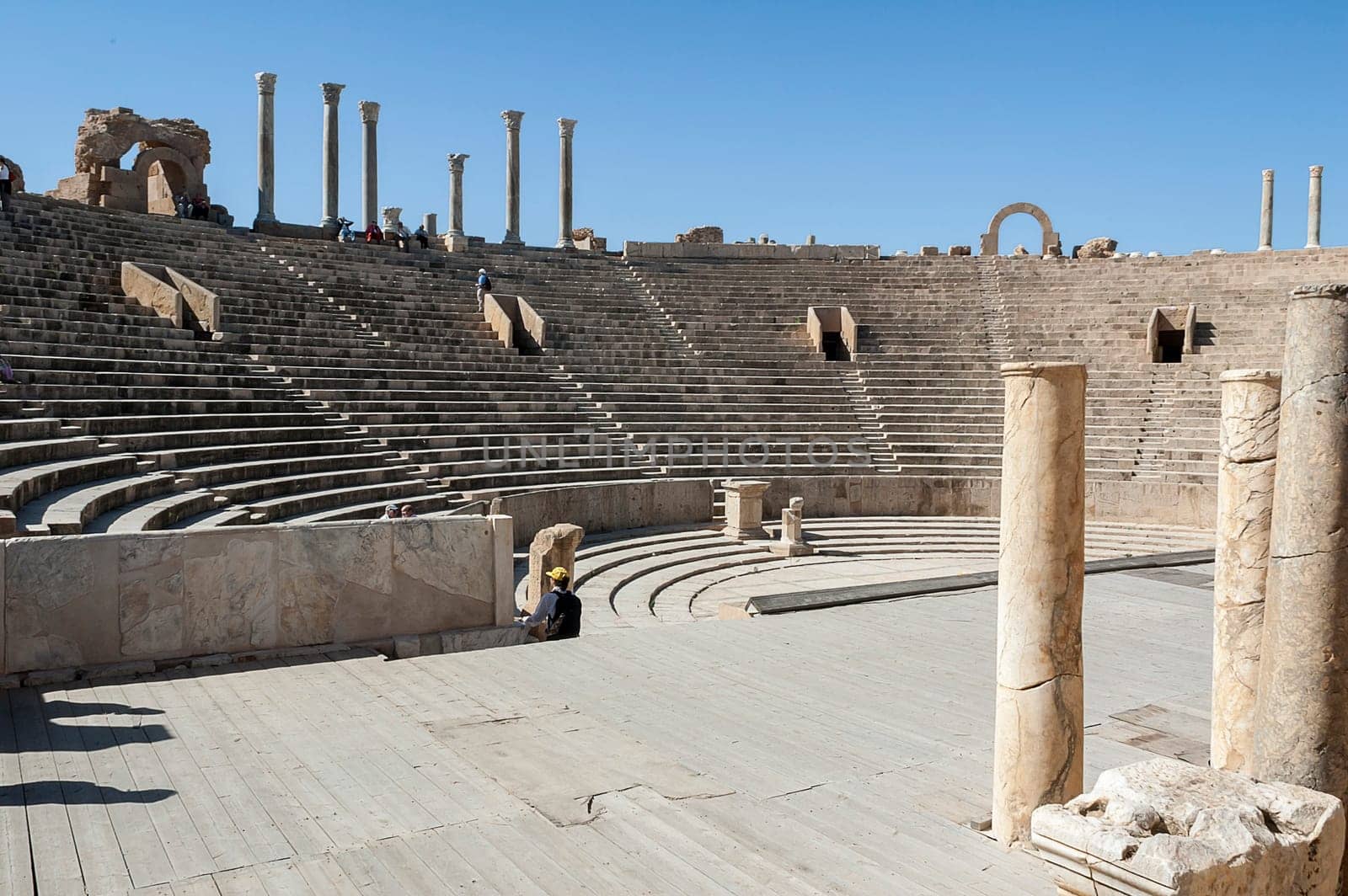 Archaeological site of Leptis Magna, Libya - 10/30/2006: Tourists at the ancient theater in the ancient Roman city of Leptis Magna.