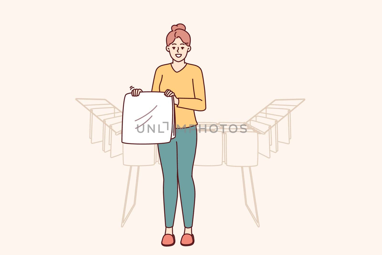 Woman housewife stands near dryer with clean towels doing household chores to create comfort in apartment. Housewife girl with washed item for advertising washing powder or aromatic laundry gel