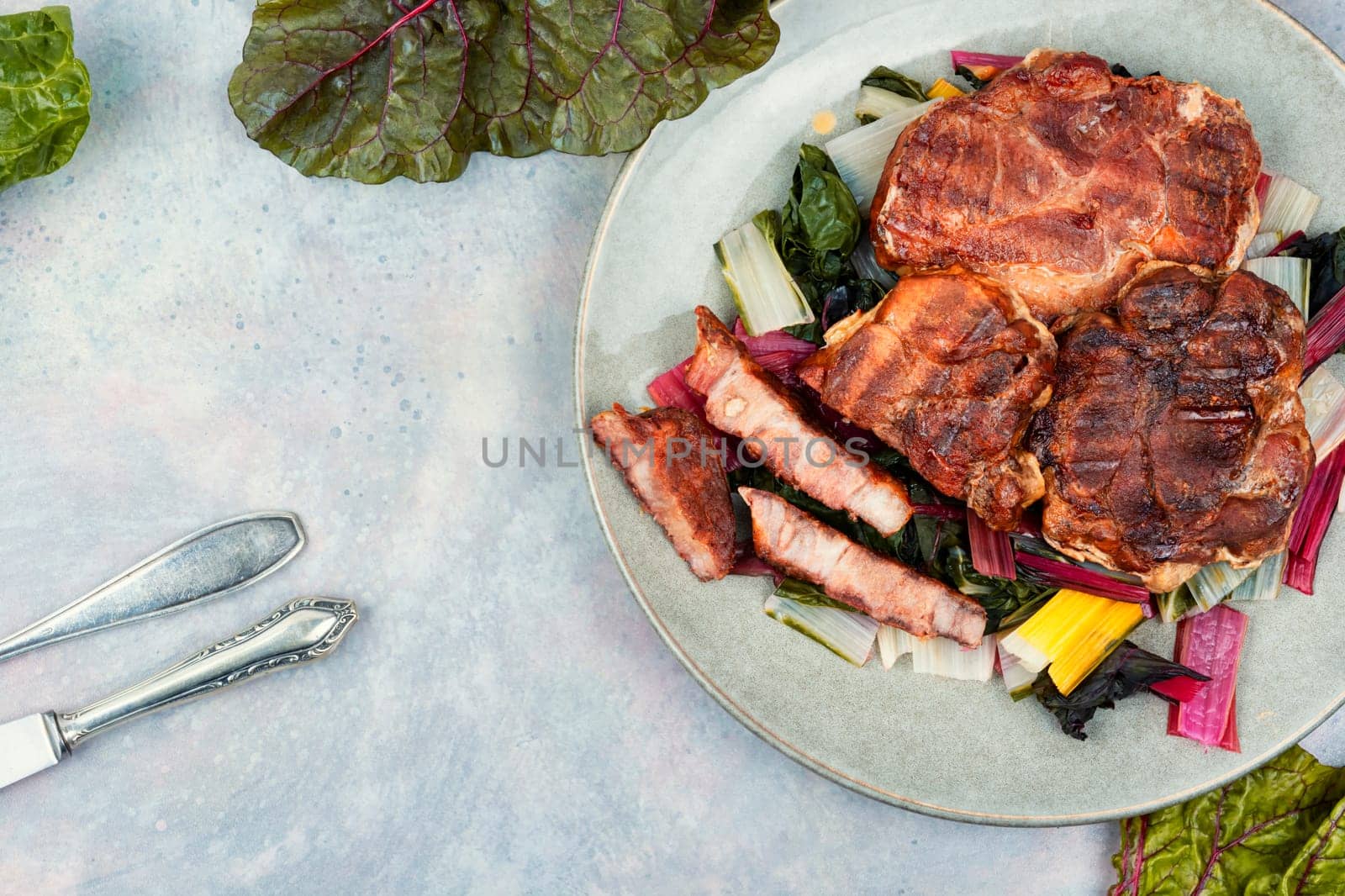 Appetizing meat steak on a vegetable pillow. BBQ grilled steak.