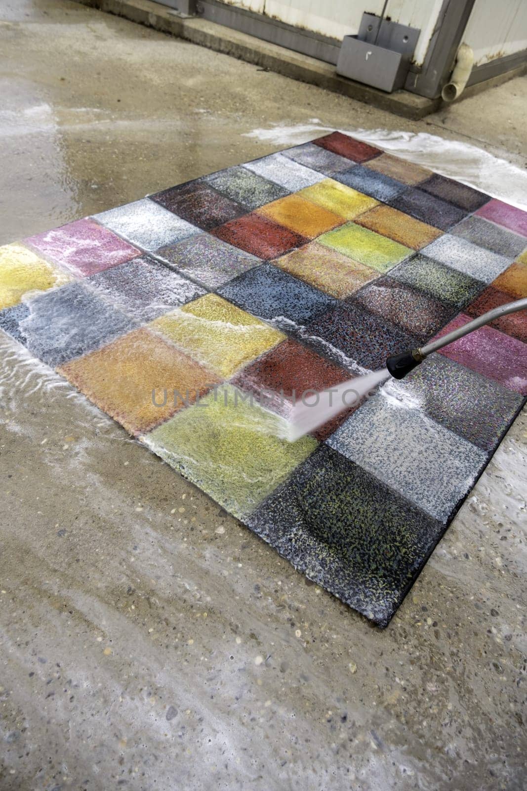 Detail of cleaning with pressure water of colored carpet
