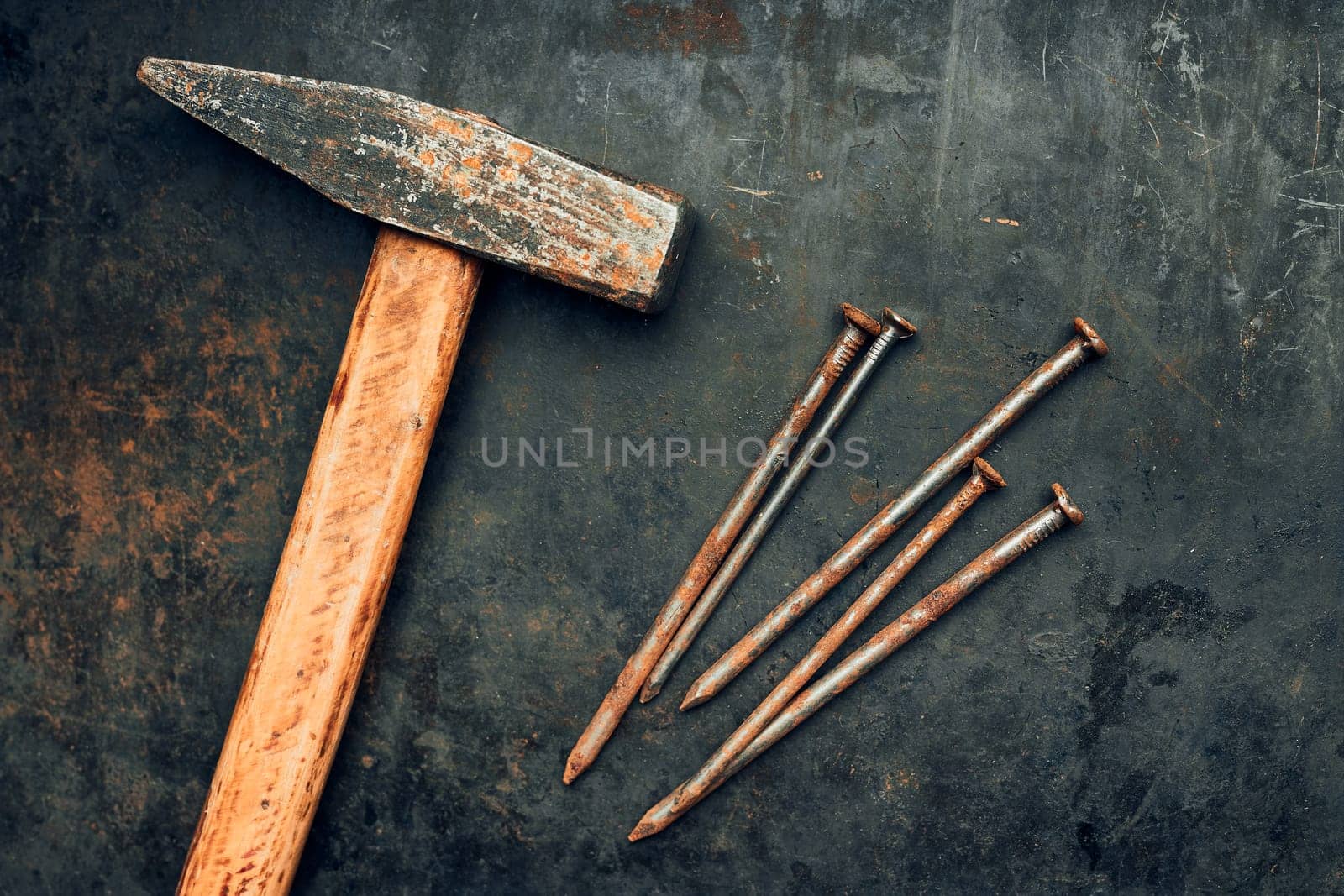 Hammer and nails on steel surface. Tools for maintenance. Hardware tools to fix. Technical background with copy space