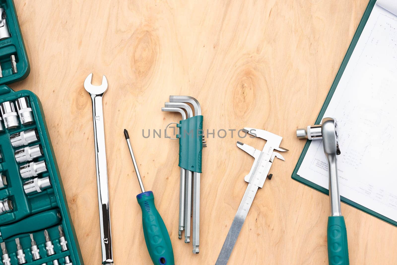 Workshop table with many tools. Wrench, spanner, calliper and ratchet with many attachments. Work tools. Universal tool set. Professional equipment. Background