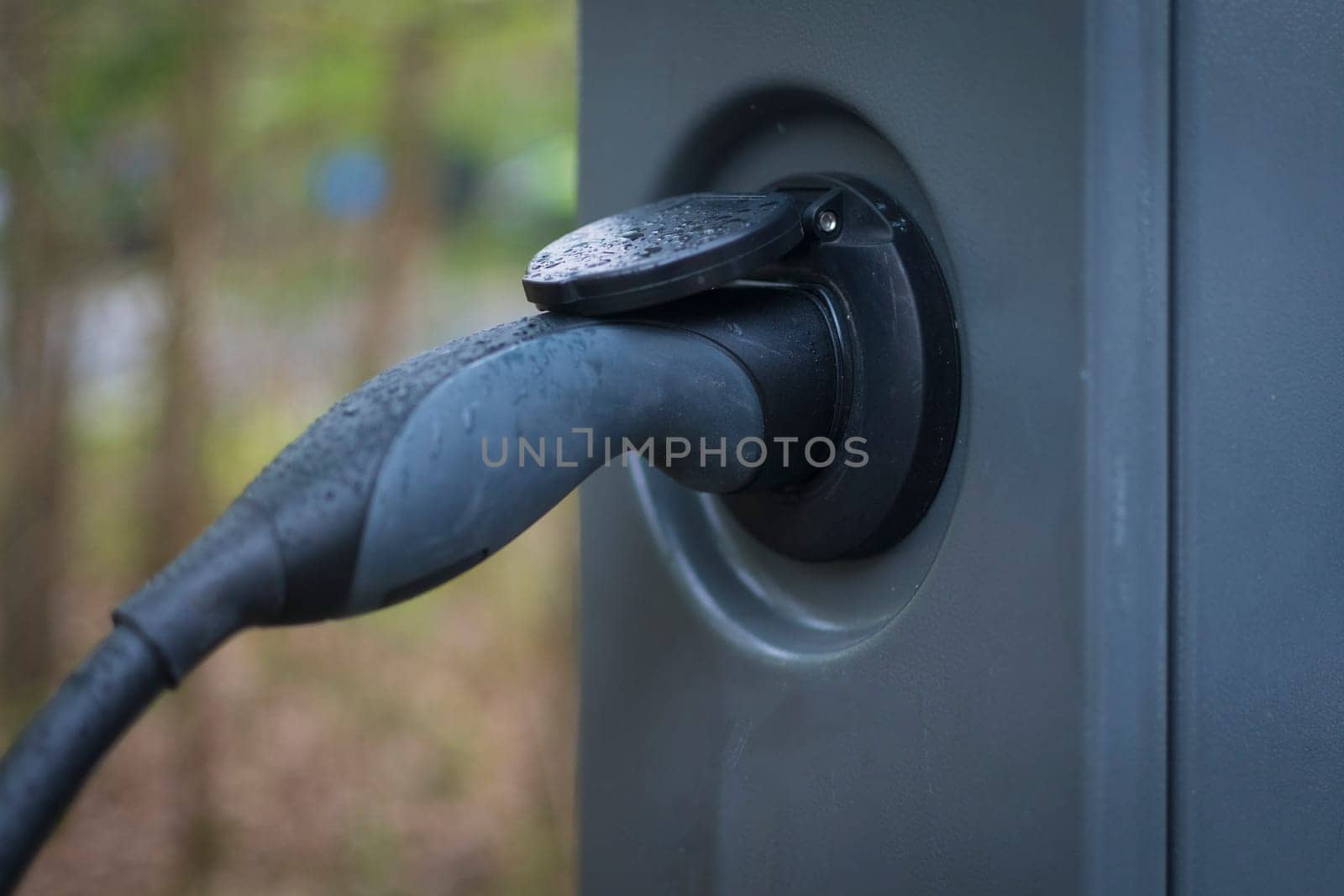 Closeup shot of a car charging cable plugged in a charging point