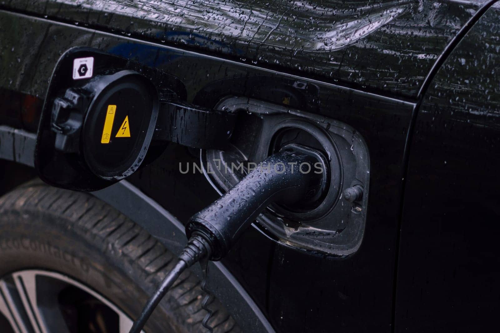 Electric cable plugged in for charging a hybrid vehicle
