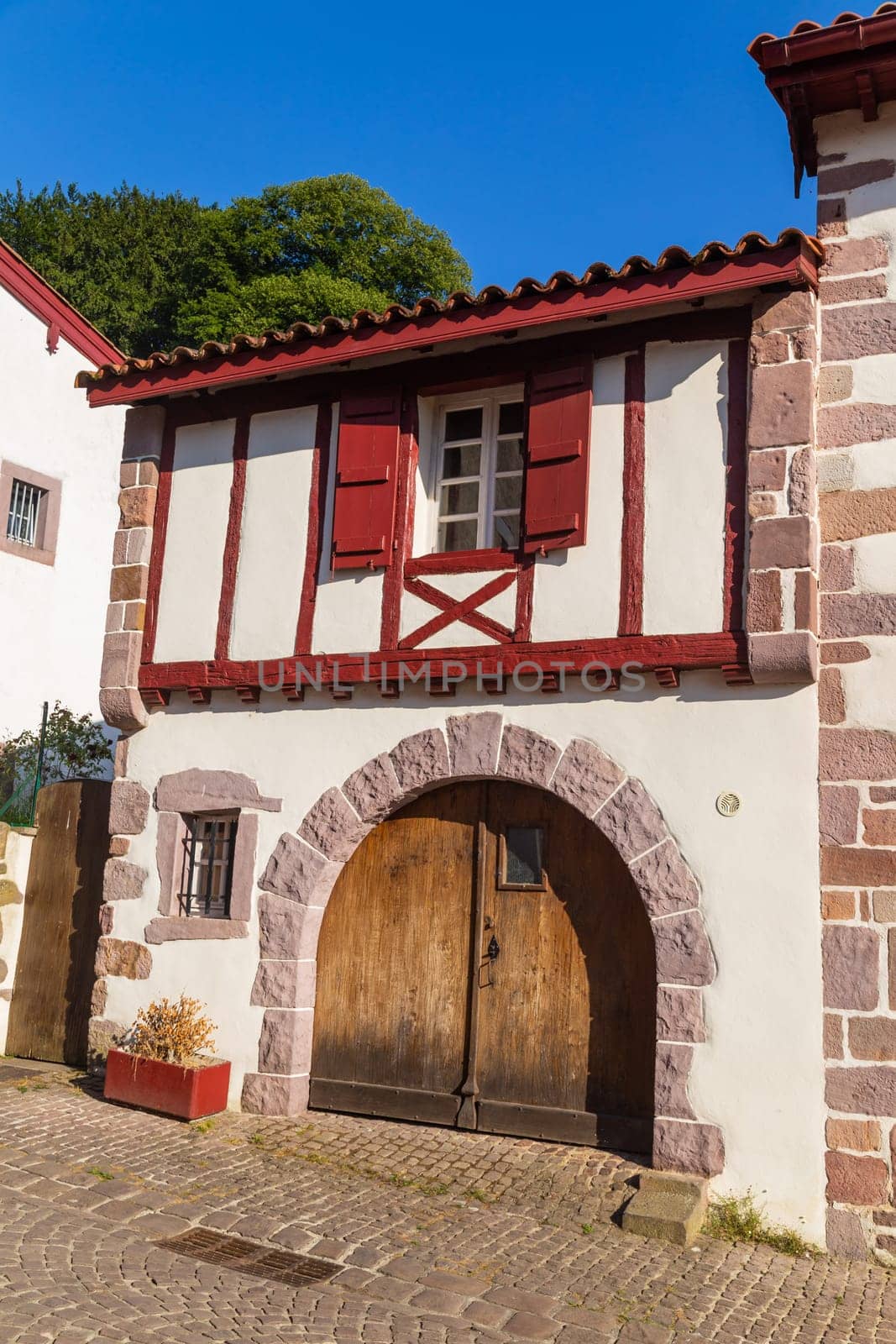 Saint-Jean-Pied-de-Port: 3 August 2022: Front view of Basque traditional building in French Basque country, Low Navarre, Atlantic Pyrenees, Aquitaine, France