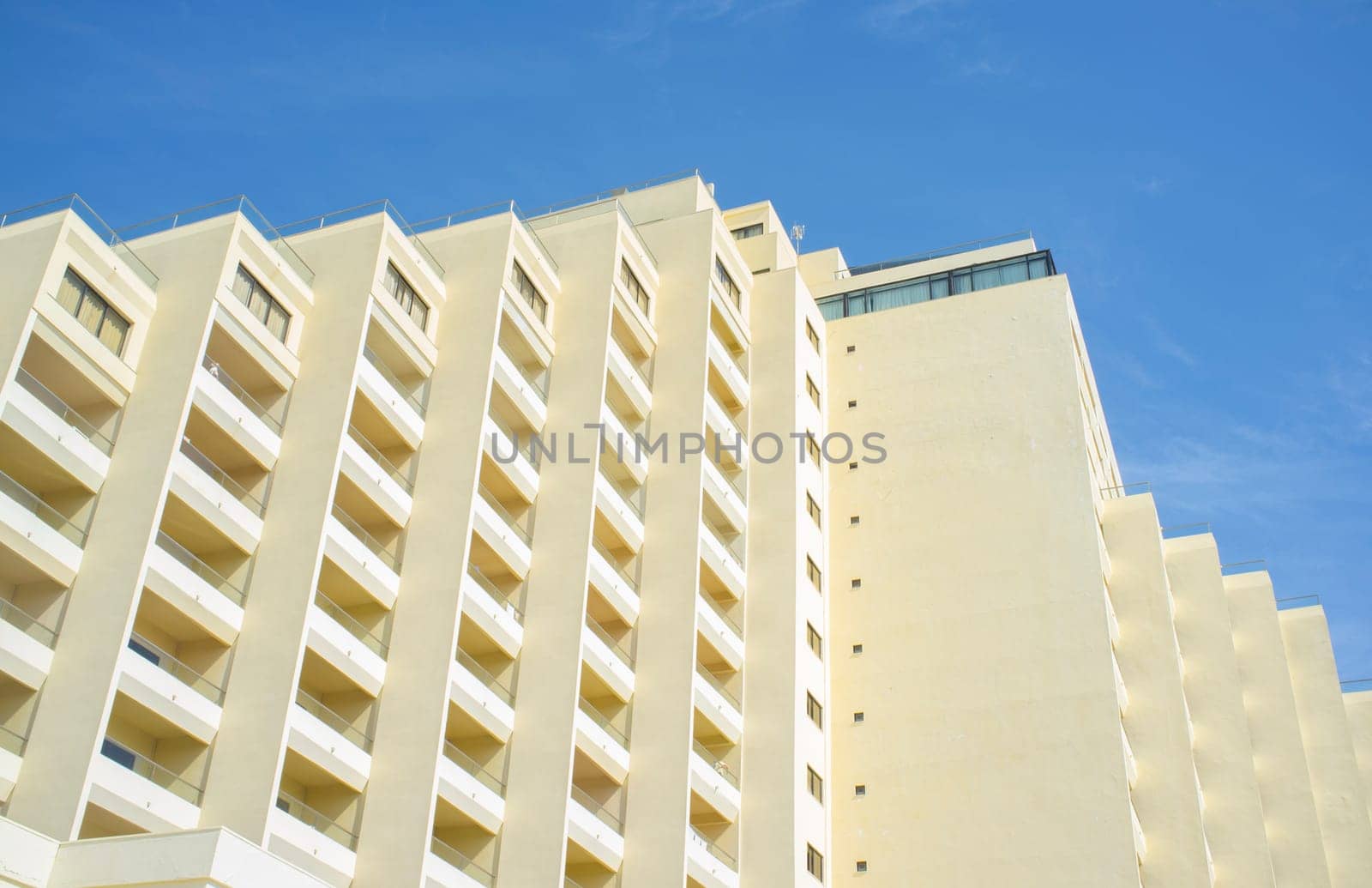 Clear block of flats over blue sky. Seventies beachfront architecture