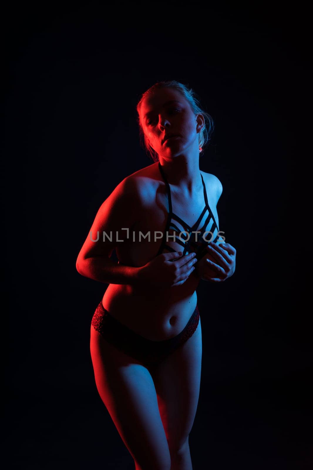 Topless sensual caucasian woman. On a black background.