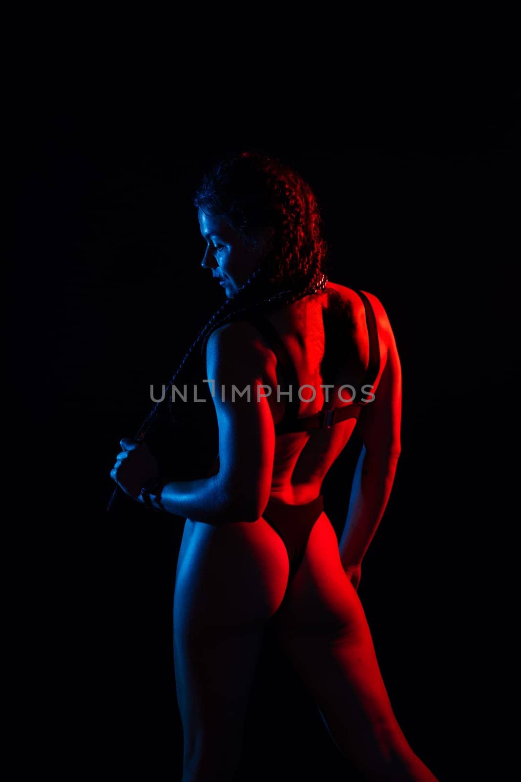 Perfect woman body on a black background studio, sport muscles belly