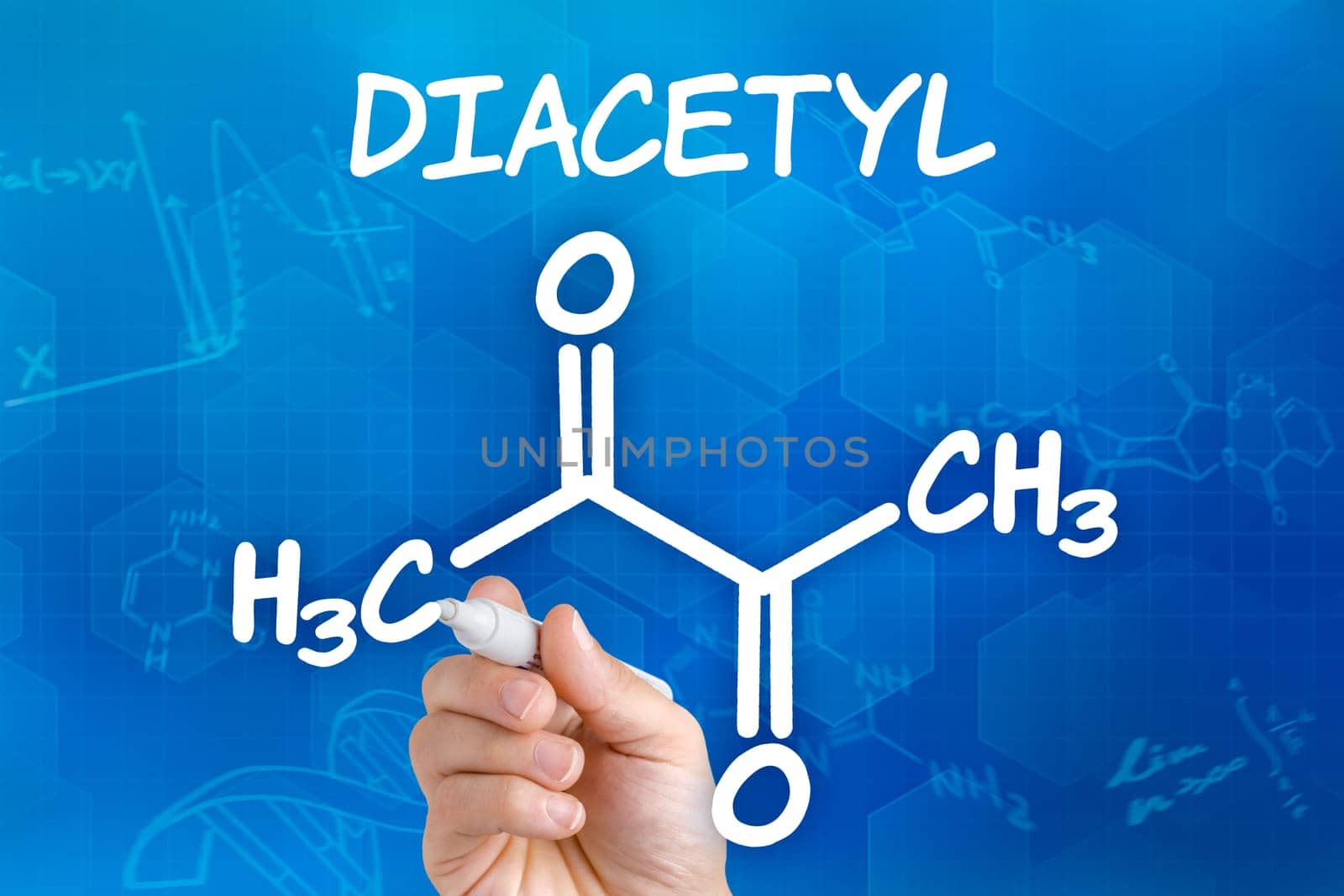 Hand with pen draws chemical structural formula of diacetyl