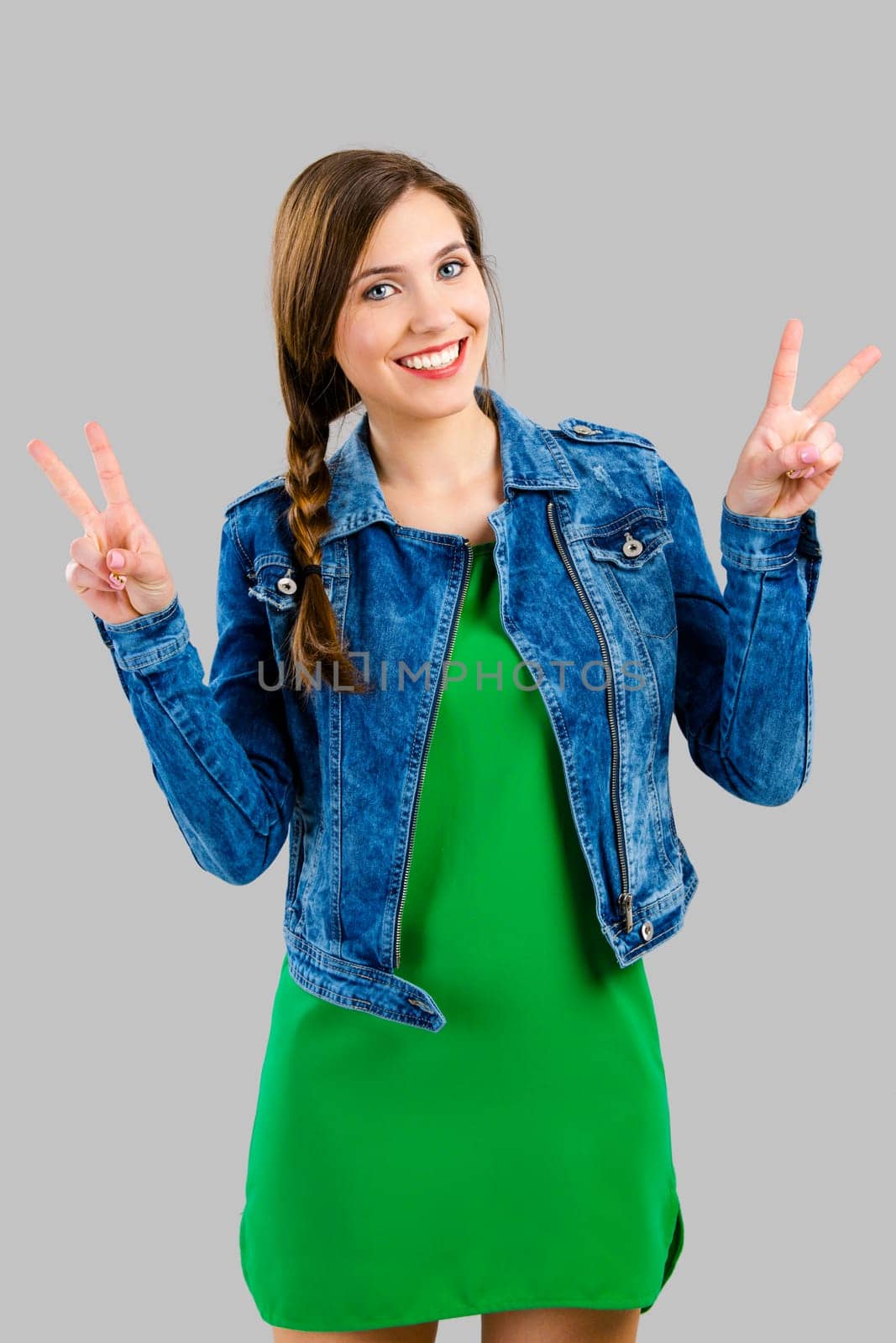 Portrait of a beautiful woman smiling over a grey background