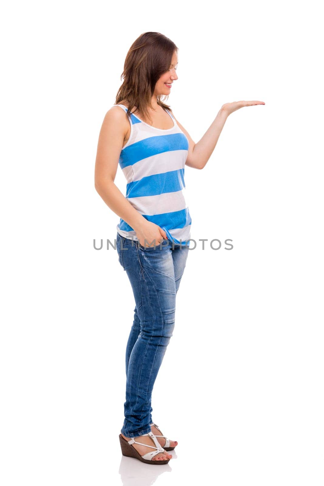 Beautiful young woman smiling and showing something on her hand, isolated over white background
