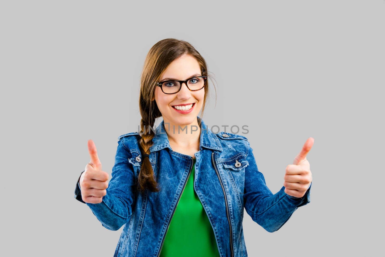 Portrait of a beautiful woman smiling over a grey background