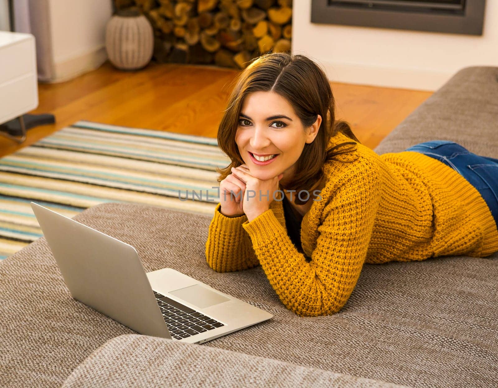 Beautiful woman working from the confort of home with her laptop