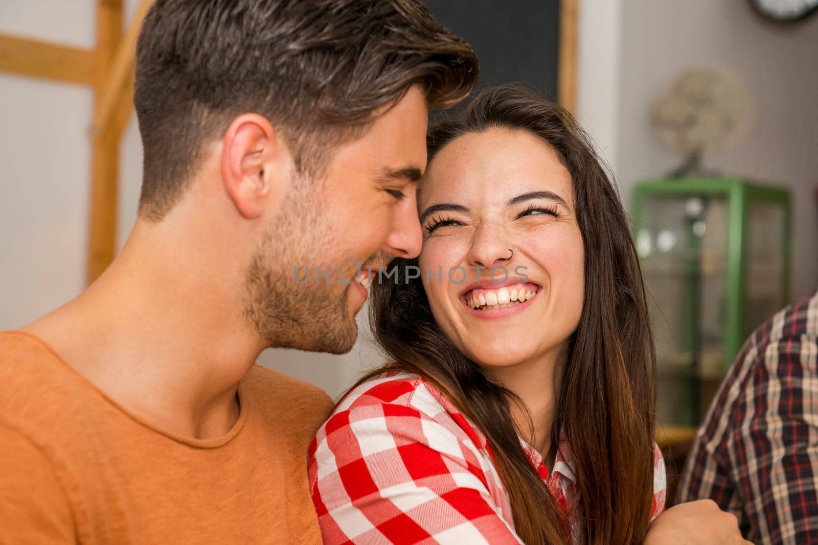 Happy couple at the restaurant talking and smiling