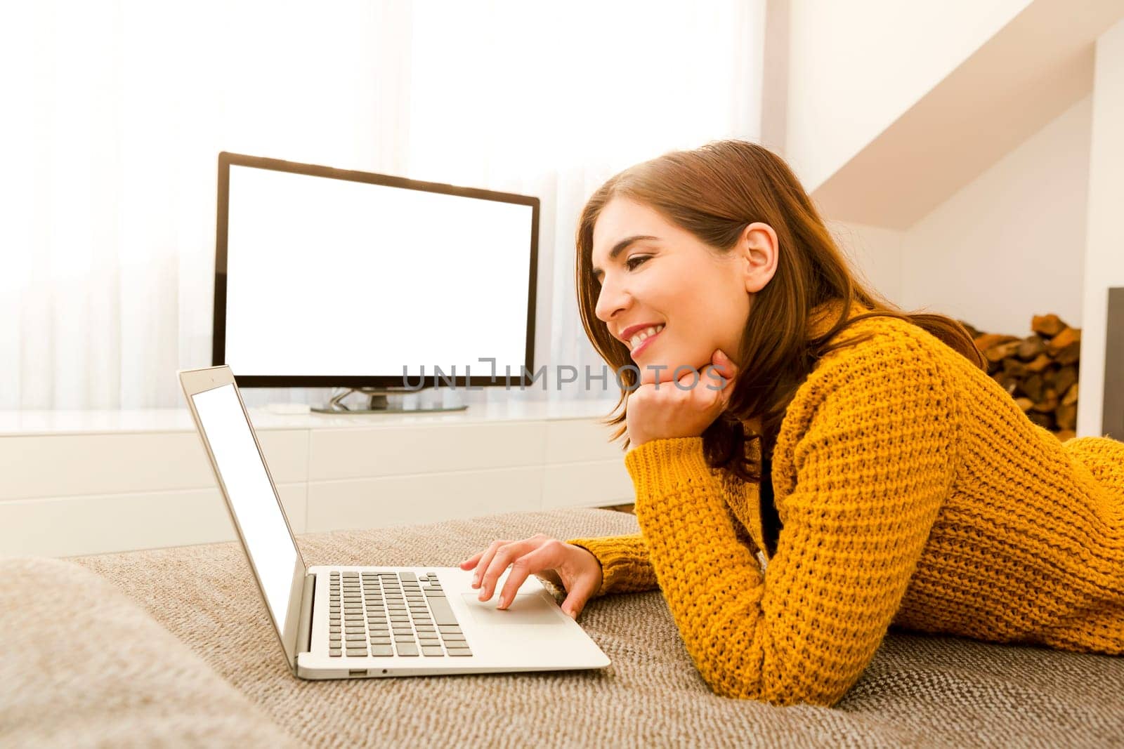 Beautiful woman working from the confort of home with her laptop