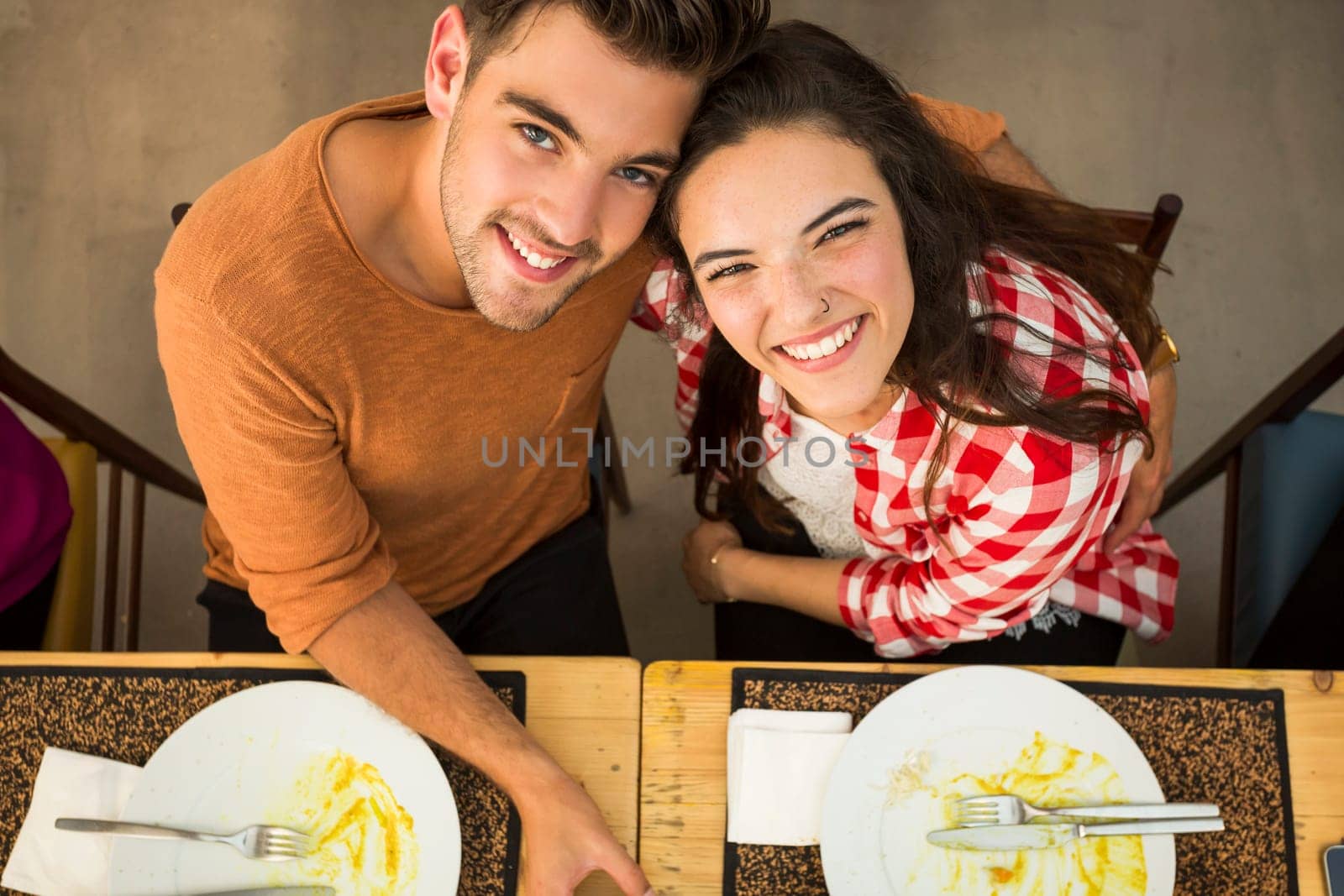 Young couple toasting and looking happy at a restaurant