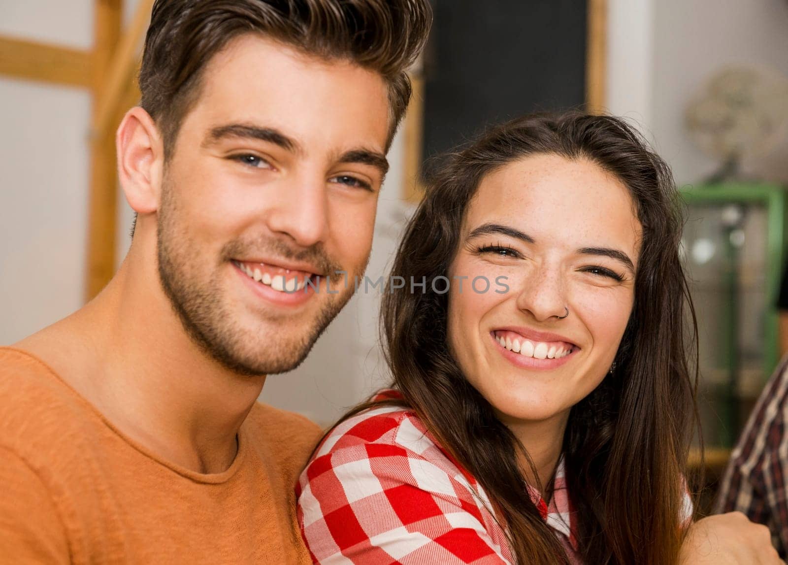 Young couple toasting and looking happy at a restaurant