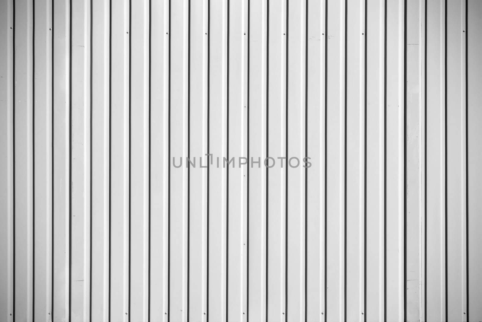 The close-up of the fluted metal wall of a construction container.