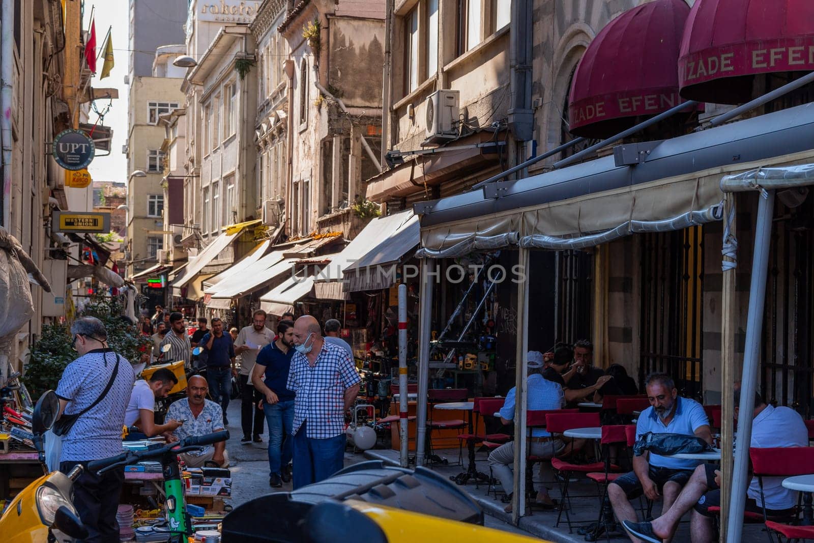 Istanbul, Turkey - July 31, 2022. Citizens walking in a typical commercial street. Istanbul, Turkey.
