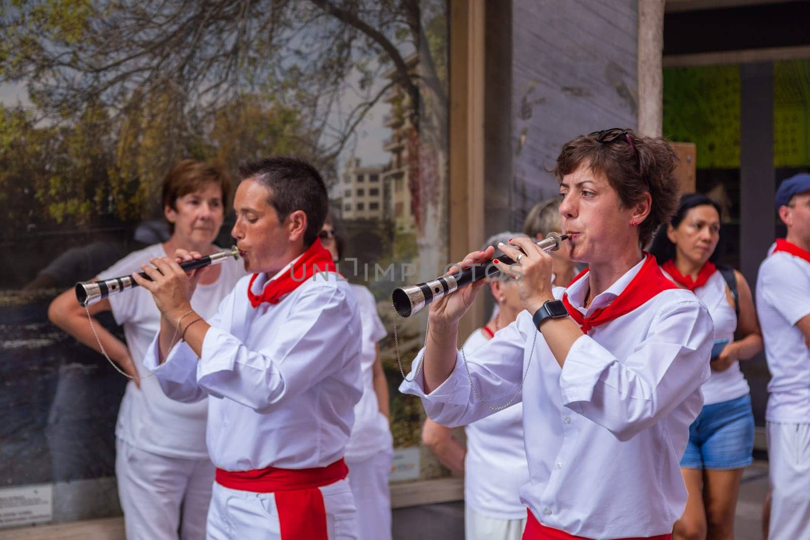 Pamplona, Navarra, Spain: 06 August 2022, People celebrate San Fermin festival in traditional white abd red clothing with red necktie, in Pamplona