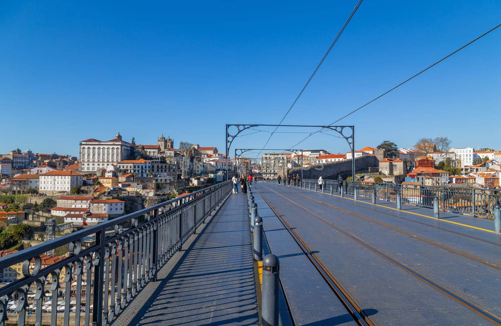 Porto, Portugal - March 02, 2023: View of Ribeira historical quarter on the margin Douro river embankment in the old town and Luis I bridge, Porto, Portugal.