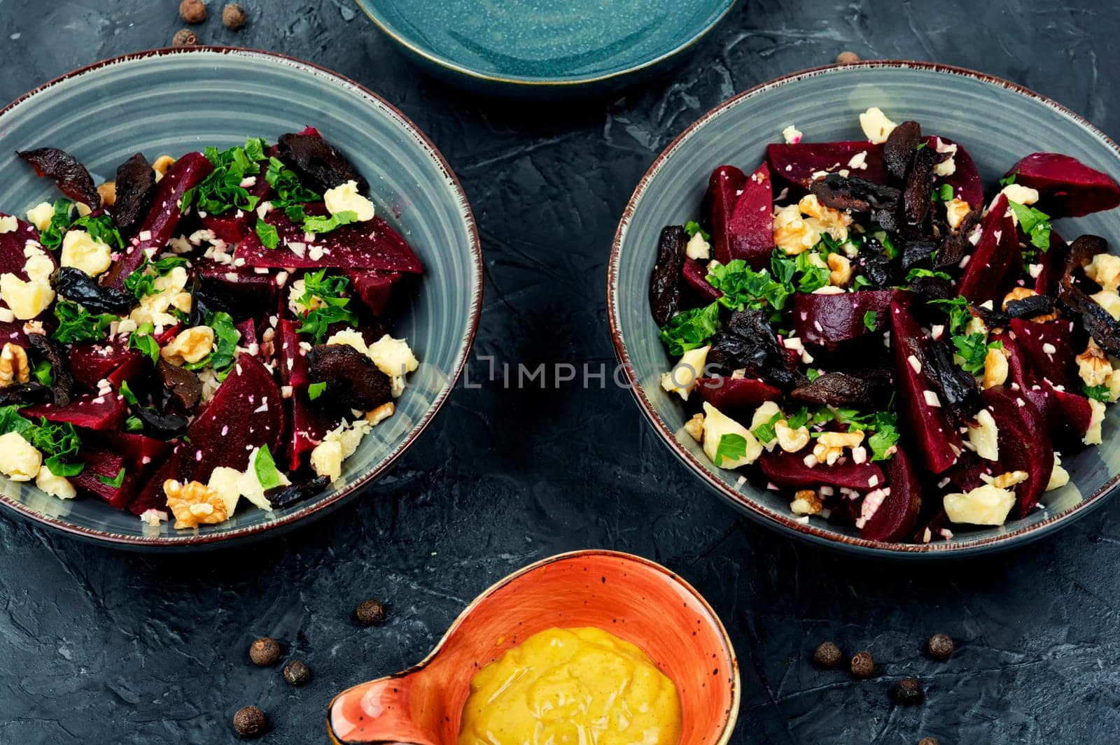 Diet salad of boiled beets, nuts and goat cheese on the plate. Flat lay.